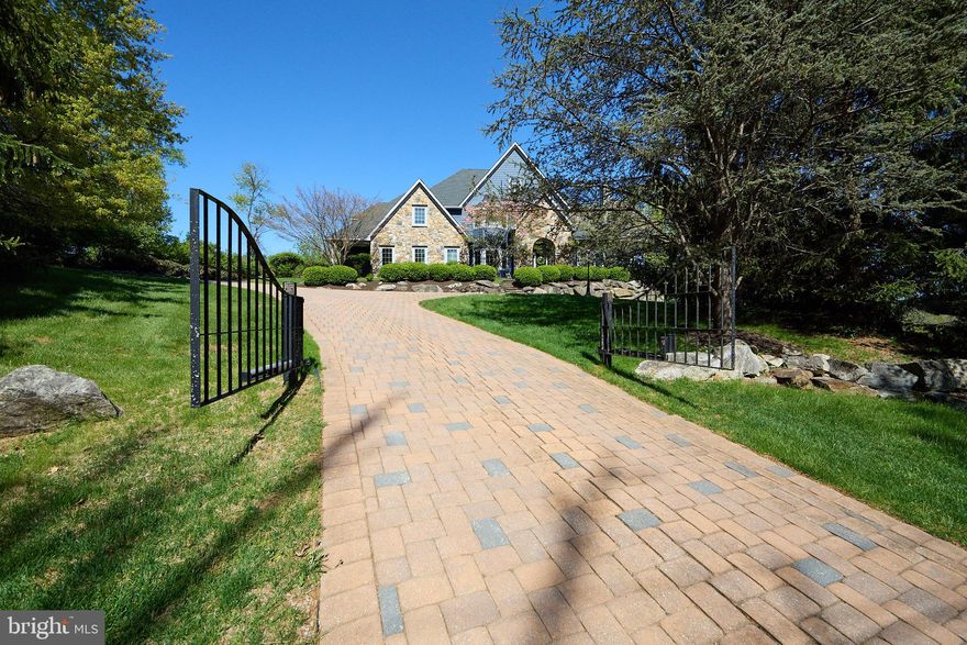 A rare offering in the heart of Chester Springs- just minutes from major roads and highways- this exceptional estate home blends privacy, elegance, and everyday flexibility. Set behind a gated driveway, the approach alone sets the tone for something truly special.  Perfectly positioned on a beautiful two acre homesite, the backyard offers and ideal setting for recreation, entertaining, or simple enjoying the peaceful surroundings and captivating views .  This impressive 6 bedroom home offers a thoughtful blend of timeless design, generous living spaces, and refined finishes throughout. Set on a picturesque lot , the property provides both privacy and convenience.  Hardwood floors extend through much of the home, complemented by detailed millwork and well-designed living spaces. The expansive kitchen features stainless steel appliances, wine refrigeration, solid wood cabinetry, quartzite countertops and a large walk-in pantry. Ample space and casual dining areas make the kitchen both functional and inviting. The main-level primary suite offers a private retreat with two walk in closets and a spacious ensuite bath.  An adjoining office with custom built ins and a gas fireplace provides flexible space for work and relaxation. Upstairs, five bedrooms offer flexible living arrangements, including a private guest or au pair suite, two bedrooms with ensuite baths and a Jack and Jill bath connecting the additional two rooms.  The exterior features usable grounds with open views, offering space for outdoor living and recreation. the 4-car garage provides parking and storage. This extraordinary property located in the Downingtown East School District with easy access to Routes 401 and 202, this home offers a combination of space, setting, and accessibility. Elegant, expansive, and ideally located- this is a home where luxury meets lifestyle in one of Chester Springs most desirable settings.