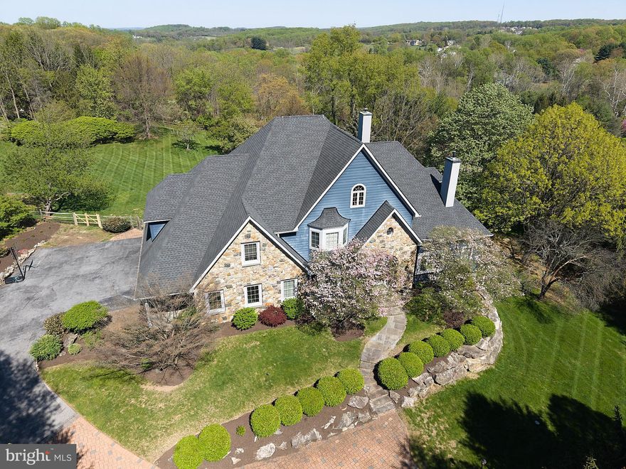 A rare offering in the heart of Chester Springs- just minutes from major roads and highways- this exceptional estate home blends privacy, elegance, and everyday flexibility. Set behind a gated driveway, the approach alone sets the tone for something truly special.  Perfectly positioned on a beautiful two acre homesite, the backyard offers and ideal setting for recreation, entertaining, or simple enjoying the peaceful surroundings and captivating views .  This impressive 6 bedroom home offers a thoughtful blend of timeless design, generous living spaces, and refined finishes throughout. Set on a picturesque lot , the property provides both privacy and convenience.  Hardwood floors extend through much of the home, complemented by detailed millwork and well-designed living spaces. The expansive kitchen features stainless steel appliances, wine refrigeration, solid wood cabinetry, quartzite countertops and a large walk-in pantry. Ample space and casual dining areas make the kitchen both functional and inviting. The main-level primary suite offers a private retreat with two walk in closets and a spacious ensuite bath.  An adjoining office with custom built ins and a gas fireplace provides flexible space for work and relaxation. Upstairs, five bedrooms offer flexible living arrangements, including a private guest or au pair suite, two bedrooms with ensuite baths and a Jack and Jill bath connecting the additional two rooms.  The exterior features usable grounds with open views, offering space for outdoor living and recreation. the 4-car garage provides parking and storage. This extraordinary property located in the Downingtown East School District with easy access to Routes 401 and 202, this home offers a combination of space, setting, and accessibility. Elegant, expansive, and ideally located- this is a home where luxury meets lifestyle in one of Chester Springs most desirable settings.