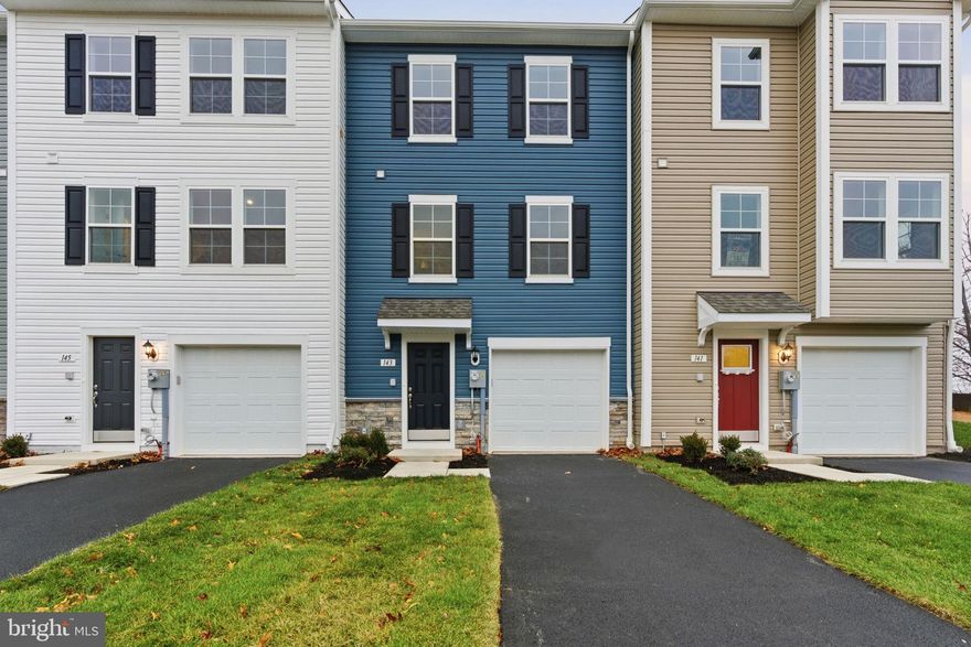 *OFFERING UP TO $18K IN CLOSING ASSISTANCE FOR PRIMARY RESIDENCE WITH USE OF APPROVED LENDER AND TITLE.*
Don't miss the last new 1,571 finished sq. ft. York II Garage home with private views off the FRONT and Back of home and with bath or powder room on every level available at close-out pricing. This striking Pacific Blue vinyl sided townhome with stone water-table offers a 40 ft. asphalt driveway, fully sodded front & back yard, front landscaping package and has the most LUXURY FINISHES of our remaining townhomes. Step inside to a welcoming foyer with luxury vinyl plank flooring and a large coat closet. The garage on the right includes a garage door opener, insulated garage door and a convenient outdoor keypad for easy access. Walk back to the finished basement with a daylight window, upgraded carpet and padding, including powder room and convenient finished storage closet. Basement has included overhead low-profile LED light and prewire for cable and data upgraded carpet and padding. Climb the 40-inch-wide staircase offering two landings and stained sculpted handrails to the main floor, which is dressed in durable, waterproof luxury vinyl plank flooring on the entire level. This kitchen offers a beautiful 8.5+'quartz prep island with overhang with room for 4 counter-height stools. The warm wood 42" upper cabinets reach all the way to the ceiling offering added shelving. The cabinets are accented by 3 oversized black pendant lights; matte black cabinet knobs and a black goose neck pull down kitchen faucet with sprayer. The stainless refrigerator, range, microwave, and dishwasher are all complimented by the wide and deep stainless farm sink. Convenient pantry with 5 wire shelves holds kitchen appliances and chef's ingredients. Next to the kitchen is a breakfast area with sliding glass doors to a composite 10 x 10 deck with steps to backyard. The view from the back of the home in beautiful weather treats you to lovely sunsets. The family room off the kitchen offers pre-wire for fan-light and a pre-wire for data or cable. Kitchen, breakfast, and family room all feature low profile energy efficient LED lighting. A convenient powder room is off the family room. Upstairs the primary bedroom will fit a queen bed beautifully and offers a vaulted ceiling with a ceiling fan pre-wire. Primary bedrooms also have private sunset views. The ensuite bath features a step-in shower with glass door and ceramic tile shower with convenient glass corner shelf. Two sinks with a quartz vanity top give this bathroom an elevated feel. A walk-in closet and linen closet with 5 wire shelves are included in the primary suite. Hallway features low profile LED lighting leads to laundry closet with included washer dryer and hall bath shared by 2 secondary bedrooms with ceiling fan/light prewires. This home is just minutes from MD-PA line, Walmart, dining and downtown Hanover shopping and dining. This townhome offers R-21 exterior wall insulation, 2 x 6 exterior wall framing, Fire retardant core wall between homes (insulation and noise reduction), insulated windows and exterior doors, and R-49 blown attic insulation. Appointments recommended.