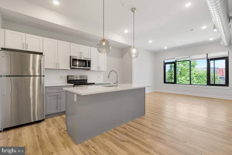 Available for IMMEDIATE MOVE IN This spacious and light drenched 2 bedroom/2 bathroom third floor unit is well appointed with a sleek and modern kitchen, wood floors throughout with in-unit washer/dryer and  intercom system.   The kitchen has stainless steel appliances inclusive of electric stove, built in microwave with vent, fridge, and dishwasher.  The island has an inlaid kitchen sink and ample space for seating additional guests during gatherings.  The living area is open and airy; just awaiting your decor to make it your home.   The  primary bedroom has large windows, walk in closet and private full bathroom with glass shower. Fitness center in building for added convenience as well as an outdoor common area perfect for grilling and enjoying the summer days.  About The Neighborhood: Located just one block from the York-Dauphin MFL Septa station, you'll have quick access to Fishtown, Temple Area, Center City in just minutes! The Septa 3 and 39 buses are conveniently on the same block, and local favorites like Martha, Atlantis the Lost Bar and Franny Lou's Porch are all within walking distance.  Pets are conditional on owner's approval and may require an additional fee, if accepted. (Generally $500/dog and $250/cat, or monthly pet rent). Tenants responsible for all utilities: $65 flat water fee, electricity, cable/internet. WELCOME HOME! (note: pics are of like kind unit)