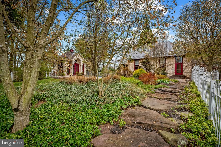 Enchanting 1800s converted Sparks school house well-sited atop a gentle knoll.  Follow the tree-lined driveway to a secluded haven. Architect-designed house and gardens create a seamless blend of interior and outdoor spaces. The in-ground pool is perfect for a swim after work, or host a garden party on the luscious grounds. Designed to reflect a Tuscan streetscape, the interior architecture features exposed stone walls, large windows allowing natural light to enter from all angles, and a blue-painted ceiling to mimic the sky. The triangular pediment feature in the family room recurs on the end walls of the bathroom, the hallway to the staircase, and on the pool house. Originally renovated in the early 1990s, the home has undergone recent renovations with the addition of the mud room with closets, cupboards, and bookshelves and the two-car garage. The finest of materials were used in the renovations, with careful attention to the high-end appliances, marble bathroom, leather-style granite counters in the mud room, custom forged handrails, and more. Propane furnace and central air conditioning systems replaced in 2024. Pool and patio renovation completed in 2024. The original schoolhouse windows were repurposed to the pool house. Follow the stone pathways through the gardens which offer year-round glimpses of color and texture. Plans for an addition will be passed along to the buyer.