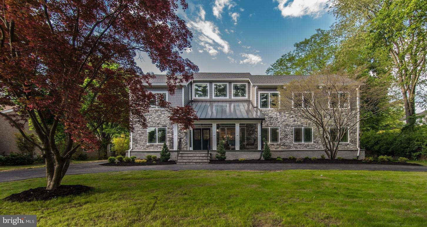 This gorgeous 6 bedroom/5.5 bath new construction in the heart of Penn Valley is the perfect home for you and your loved ones! The moment you arrive you will be amazed. Walk through the double doors into the sprawling open concept first floor. Natural light pours into this home from every angle, casting a warm glow across the beautifully finished hardwood floors throughout. You’ll immediately notice the dual side fireplace, inviting you to come inside. The inviting entranceway will lead you to the heart of the home, where you will find a beautiful kitchen with quartz counters, ceiling height cabinets and an industrial size fridge. The kitchen also features a private pantry and a wine bar. Follow the flow into the family room, with a custom gas fireplace to relax and enjoy some time with the family. A few more footsteps will lead you into another beautiful space for a living room or great room and a semiprivate dining room. The dining space allows for plenty of room to gather with your friends and loved ones, while enjoying the ambiance of that dual sided fireplace!
The first floor also features a guest bedroom with on suite full bathroom. There is also a space for an office or reading room…the possibilities are endless.
On your way up the wrought iron staircase you admire the custom shadowbox design on the walls. The custom design showcases the true height of these ceilings and leads you to a loft that overlooks the first floor. The second floor contains 4 generously sized bedrooms with ample closet space and plenty of natural light. The hall bathroom features a full size glass shower and a separate tub. You will also conveniently find the laundry room on the second floor as well, complete with a full size fridge! The highlight of the second floor is the remarkable master suite, with a spa like master bath and a humongous walk-in closet. The closet features custom shelves and drawers, with no lack of space to hang or store your favorite items.
We aren’t done yet! Heading back down to the first floor, you can retreat down to fully finished basement or ground floor of the home, where you will find a full bar and plenty of room for another family room, dance floor, workout space or just general entertainment! The ground floor also houses a convenient full bathroom complete with a glass shower.
The rear of the property features a two car garage and a beautiful private deck, with ample space to relax and enjoy the beautiful views of the sprawling backyard. This home has it all – over 5,000 square feet of living space, high end finishes, custom woodwork and beautiful grounds, conveniently located near major highways, restaurants and shops. Come on over to view this exquisite property today and make it your home tomorrow!