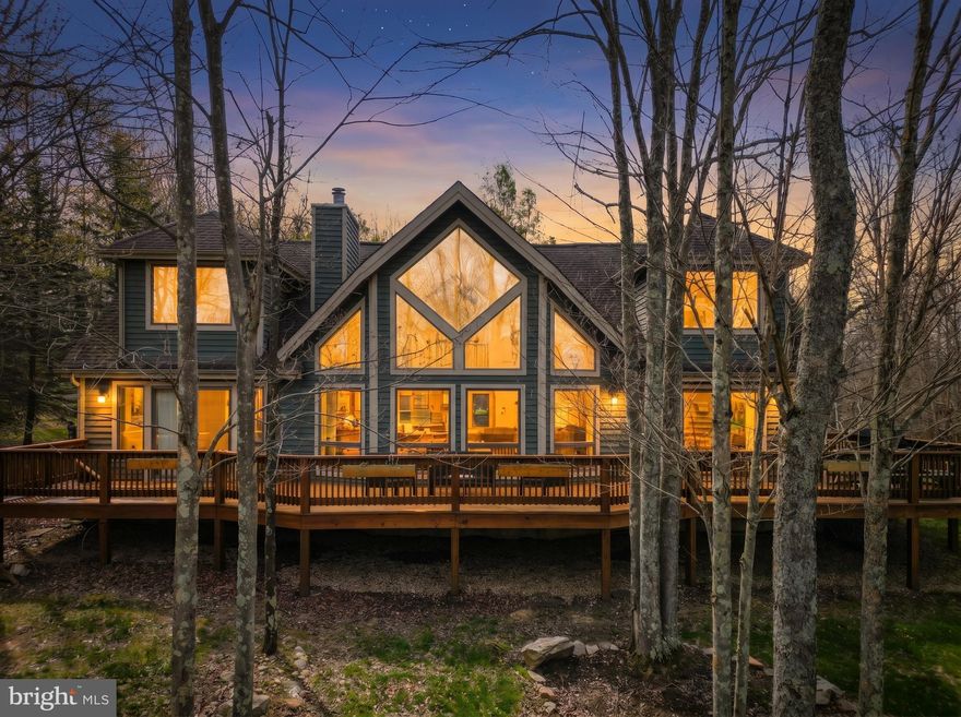 Tucked within The Pinnacle at Deep Creek Lake, this beautifully maintained lake access home with an assigned dock slip offers the perfect blend of comfort, style, and location. Designed for easy living, the open floorplan features warm hardwood flooring, a striking wood-burning stone fireplace, and a well-appointed kitchen with an oversized island ideal for gathering.
Natural light pours in through expansive windows, creating a seamless connection to the surrounding landscape. The private suite above the two-car garage adds valuable flexibility—perfect for guests, overflow sleeping, or a quiet retreat.
Outdoor living shines with a spacious wraparound deck, offering filtered lake views and the ideal setting for relaxing summer evenings. Residents of The Pinnacle enjoy access to a lakeside clubhouse, tennis courts, and well-maintained roads perfect for walking or jogging.
Whether you're searching for a full-time residence, vacation getaway, or investment opportunity, this home delivers the complete Deep Creek lifestyle.