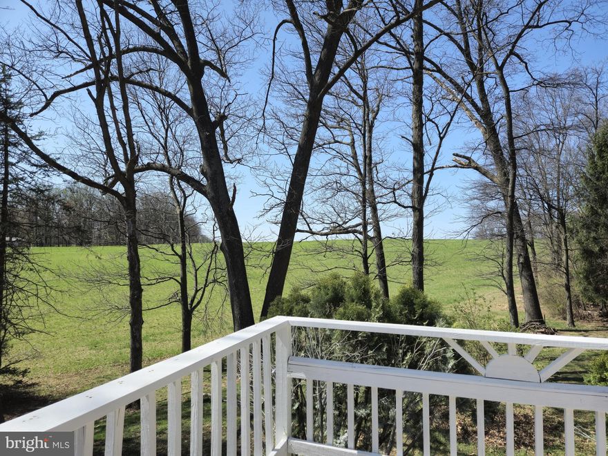 Step out of the kitchen onto a deck to enjoy scenic farmland views.  This home has been completely updated to included new HVAC, electric, plumbing, hot water heater and beautiful designer details throughout.. The primary bath boasts a gleaming tiled walk in shower and free standing tub.
Hardwood  floors flow throughout main level, and low maintenance durable LVP covers the lower level.  All baths have beautiful ceramic floors and surrounds.
A gorgeous exposed beam opens rooms between  the kitchen and family room,. 
The finished basement is full of possibilities with a  large rec room area, laundry area, walk out entrance, and owners choice separate room. This gem won't last long!