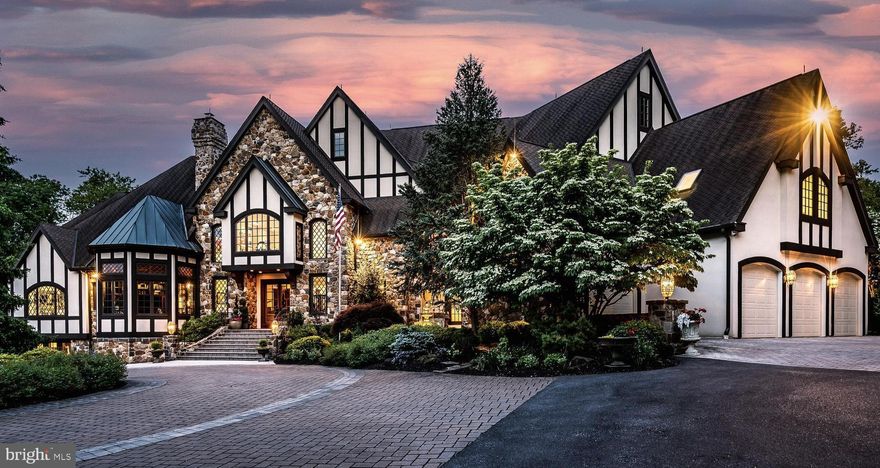 One of the most remarkable private executive estates in the Delaware Valley, this exquisite 12,000+ square foot, 6 bed, 8+ bath Tudor manor home estate on over 7 acres in Unionville-Chadds Ford School District, is available to become your sanctuary. With secured privacy and handcrafted luxury throughout, the property has been updated by the present owners to the highest standard. A breathtaking foyer welcomes you to the grand formal Living Room with dramatic fireplace and custom cabinetry. The soaring vaulted ceilings with floor to ceiling windows showcase private views of the manicured grounds. There is a stunning masterpiece Kitchen and Butler Pantry with an additional Chef's Kitchen. The Master Suite with his/her separate baths and Walk-in Closets, and stunning Study is an oasis within an oasis. The fully finished Lower Level provides 5,000+ square feet of living space and is replete with entertainment areas, a Game Room, two Exercise Rooms, Sauna/Steam Room, Wine Cellar and amazing 12 person Home Theater. The Upper Level offers four bedroom suites and a fully equipped guest suite. There is an elevator and several staircases to easily move between all floors. In addition to the main home, two ancillary buildings occupy the grounds: a 3-room Office Studio and a Pool House with small kitchen, bath and more. These additional spaces lend themselves to offering a family compound or they would be ideal for conducting your business from home. For the car enthusiast, there are 11 garage spaces - four attached and an additional seven detached. The gorgeous Sylvan free form pool is the center of spa-like exterior spaces for entertaining and relaxing with family and friends and are superior to those found at five star resorts. This unsurpassed property is conveniently located with easy access to West Chester, the Main Line, Philadelphia, and Wilmington.