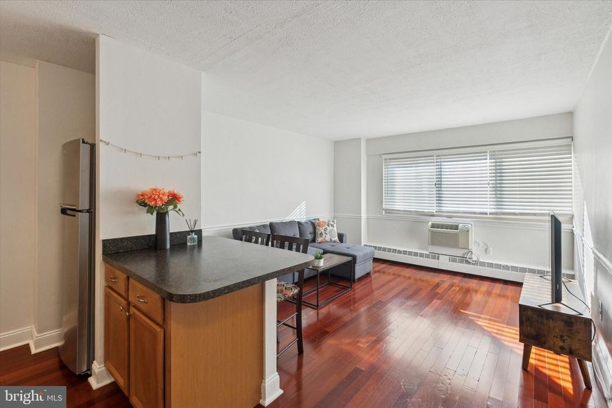 Call Rittenhouse Square home. This beautiful, south facing, light-filled one-bedroom, one-bath condominium is located on a high floor with unobstructed city views. This spacious residence features an open floor plan with upgraded flooring, and a generously sized bedroom, ample closet space, and a wall of windows that showcases the skyline. The updated bathroom includes modern floor and wall tile, a glass-enclosed shower with built-in bench, and a beautiful vanity. Set within the highly sought-after River West Condominium, you’ll enjoy exceptional amenities: secured access entry, a recently renovated lobby, 24-hour front desk/concierge, state-of-the-art fitness center, on-site laundry, and a media/business center with conference room and FREE Wi‑Fi in common areas. An attached garage is available with a separate charge for parking. With a 100 Walk Score and 100 Transit Score, you’re moments from premier dining, shopping, museums, and theaters, plus Trader Joe’s, Whole Foods, Giant, Di Bruno Bros., and the Rittenhouse Square farmers’ market. Enjoy easy strolls to Rittenhouse Square Park and the Schuylkill River Trail, and a convenient walkable commute to Center City businesses, UPenn, Drexel, and CHOP.