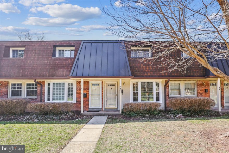 Step inside this charming and bright 2-bedroom, 1.5-bathroom condo townhome, offering a spacious and open floorplan with a beautiful bay window that fills the space with natural light, located in the sought-after Winter Hill community in Falls Church City!  The gleaming hardwood floors flow throughout both levels, complemented by stylish wood shelving in the living room, primary bedroom and bathrooms. The gourmet kitchen boasts sleek granite countertops, a stylish backsplash, and plenty of cabinet space, with convenient access to a private back patio – perfect for outdoor relaxation. The inviting half bath, located off the living and dining areas, features an updated vanity and a striking, unique wood ceiling. On the upper level, you'll find a generous primary bedroom with dual closets, alongside an additional cozy bedroom. A full-size bath on this level adds to the home's convenience, and a full laundry setup completes the second floor. Tucked away on a peaceful private walkway, this home also offers a fully fenced backyard patio – an ideal retreat for privacy and entertaining – along with an assigned parking space. Just moments from the heart of Falls Church City, enjoy easy access to a vibrant selection of coffee shops, boutique shopping, and a variety of restaurants. Falls Church City Schools!