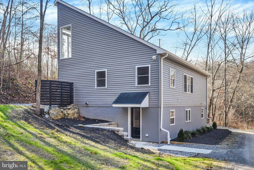 IF PRIVACY IS KEY, WELCOME TO YOUR DREAM HOME!  This completely rehabbed Colonial is a true gem, boasting an array of modern features and luxurious finishes throughout. Nestled on a secluded and mostly wooded 3-acre lot on a private road and in a private community, this home is a sanctuary of comfort and style.
The open concept living room, dining room and kitchen combo has lots of windows flooding the area with natural light, bringing a seamless connection to nature, creating an inviting ambiance that's perfect for unwinding.  You'll immediately be captivated by the stunning kitchen. It's a chef's paradise with beautiful granite countertops, stainless steel appliances, and pendant lights casting a warm glow over the peninsula. The recessed lighting adds a touch of sophistication, while the solid oak floors provide a timeless elegance. Cooking and entertaining are a delight in this well-appointed space. Just off the kitchen, you'll discover the convenience of a mudroom/laundry room and a half bath, perfectly designed for your daily needs. Plus, a custom built-in bench with coat hooks offers a practical and stylish solution for keeping your entryway tidy.
On the same level, two comfortable bedrooms await, featuring plush carpeting and ceiling fans to keep you comfortable year-round. A full bath showcases porcelain tile floors, a stunning sink, and a bathtub with a subway tile surround, giving it a touch of elegance.
The upper level of this home is a haven of luxury. The primary bedroom is a bright, spacious retreat with plate glass windows and a huge walk-in closet to store your wardrobe. The primary bath is a showstopper with its double vanity sink, walk-in shower, and a free-standing soaking tub set against custom plate glass windows, creating a serene oasis for relaxation.
But that's not all – this home also offers a huge attic area for additional storage, ensuring you have plenty of space to keep your belongings organized.
When you enter from the lower-level door, you'll be delighted to find a large, finished family room with luxurious vinyl plank floors. It's a versatile space that can be used for family gatherings, movie nights, or a home gym.  Additionally, there's an partially finished utility/storage room for all your practical needs.
This home is a rare find, combining modern amenities with thoughtful design. Each level has a piece of the homes history; exposed beams from the original structural. The home named "Rock Bottom", by the builder/remodeler, has exposed rock in the lower level as the original structure was built on the side of the hill. 
 Don't miss the opportunity to make this remarkable property your forever home. Make your appointment today and start living the life you've always dreamed of!  Use in Common Driveway Easement.  Property Zoned Conservation.