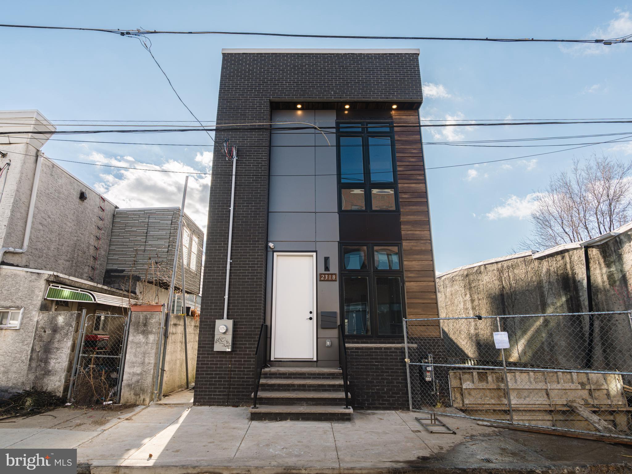 Step into a world of exquisite living at 2318 Hazzard St , where an elegant, one-of-a-kind, new construction home awaits in the hottest and most desirable area of Fishtown! This meticulously crafted sanctuary is a true masterpiece, boasting approximately 3100 sq ft of living space, 4 beds, and 4 1/2 baths. As you enter, you'll be captivated by the radiant and expansive interior, adorned with large Andersen windows , natural stunning hard wood floors, and 9-foot ceilings on every floor. The first floor unveils a custom accent walls with reclaimed accents, exquisite trim work, custom lighting, and surround sound, creating the perfect ambiance for entertaining. Journey through the first floor open floor layout, with powder room and as you walk to discover a sprawling dining area with a custom chandelier made to captivate any one, but the main focus is the double-wide dream kitchen. This culinary haven features custom white cabinets, designer tile with an exquisite waterfall quartz countertops, herringbow designed backsplash, and two large pantry cabinets, exuding a charm straight out of a fairytale. Living area is spacious and offers immense amount of natural lighting! Step into the rear of the home, the backyard is a private oasis, enveloped by brand new wood fencing, offering an ideal retreat for sipping morning coffee or perfect for relaxing on a fall evening! The finished basement presents a versatile space for a media room or home gym, complete with a spacious bedroom and full bathroom, ideal for an in-law suite. Ascend to the upper levels on a custom stainless steel cable railing, to find two spacious bedrooms, hallway stacked brand new washer dryer set, and hallway full designer bathroom with the most luxurious finishes and tilework. Bedrooms have to offer immense amount of natural light and ample closet space. The master suite on the third floor is a private sanctuary, featuring a massive walk-in closet with custom built-ins, and a luxurious bedroom area and a lavish en-suite bathroom with modern soaking tub, luxurious stand in shower and elegant double vanity. Step onto the rooftop to discover a sprawling roof deck with breathtaking views of the city, completing this magical abode. 2318 Hazzard is designed to be unparalleled! This is a dream come true designed with the most luxurious and elegant features. Nestled in the vibrant Fishtown neighborhood, this home is a short stroll from an array of bars and restaurants, and public transportation and major highways, offering the perfect blend of enchantment and convenience. Don’t let this one pass you by, stop by and have your dreams come true!