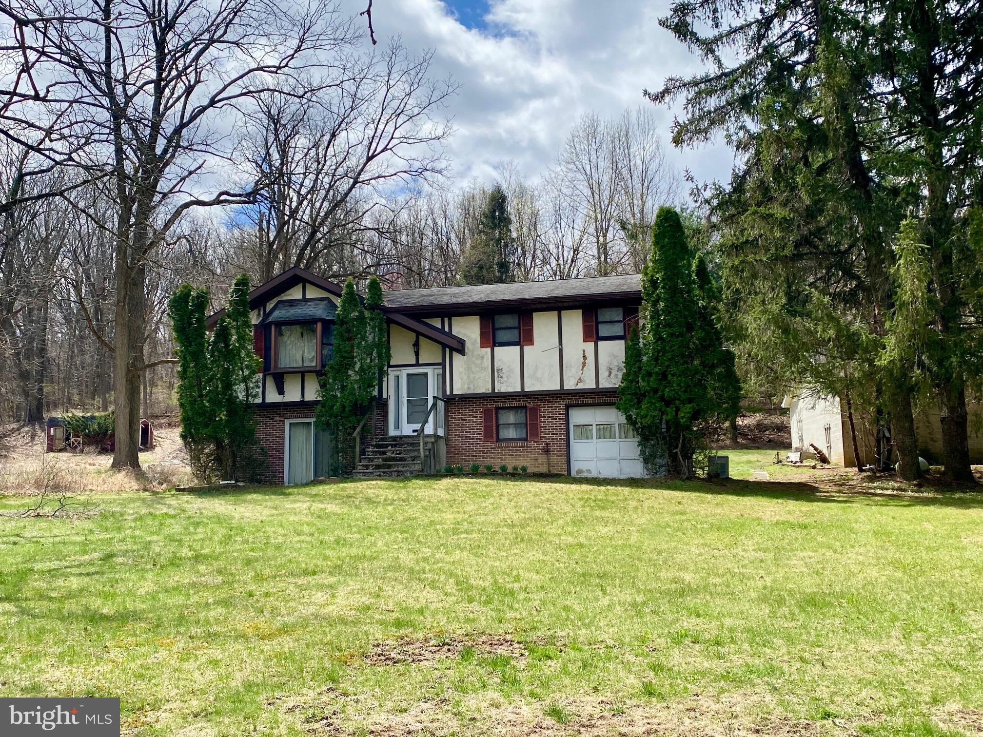 OFFER HAS BEEN RECEIVED! ALL OFFERS NEED TO BE SUBMITTED BY 1 PM ON 4/16/25. This bi-level is a handy-man special that has a beautiful rural setting and is ready for your cosmetic touches. The house (upper level) has 3 bedrooms, 1 full bath, living room, 33 handle kitchen with dinette area. The lower level consists of a family room, 2nd full bath (shower is not working), laundry hookups, and bonus room in garage (not heated). The family room has/did have water seepage at one time and will require some remediation and updating. There is electric baseboard heat and a wood stove for house. Also, the generator will be included with the sale. There is a large block garage (28'x40') that has a 2 car overhead garage door and a 1 car overhead garage door. Perfect for the car buff or for extra storage! At the driveway entrance, there is a pond that is located partially on this property and the neighbor's property. Property is being sold in "As-Is" condition for the Estate. Buyer would be responsible for removing any personal belongings. Located very close to the Berks/Lehigh County line so easy commute to Macungie, Breinigsville, and Trexlertown!