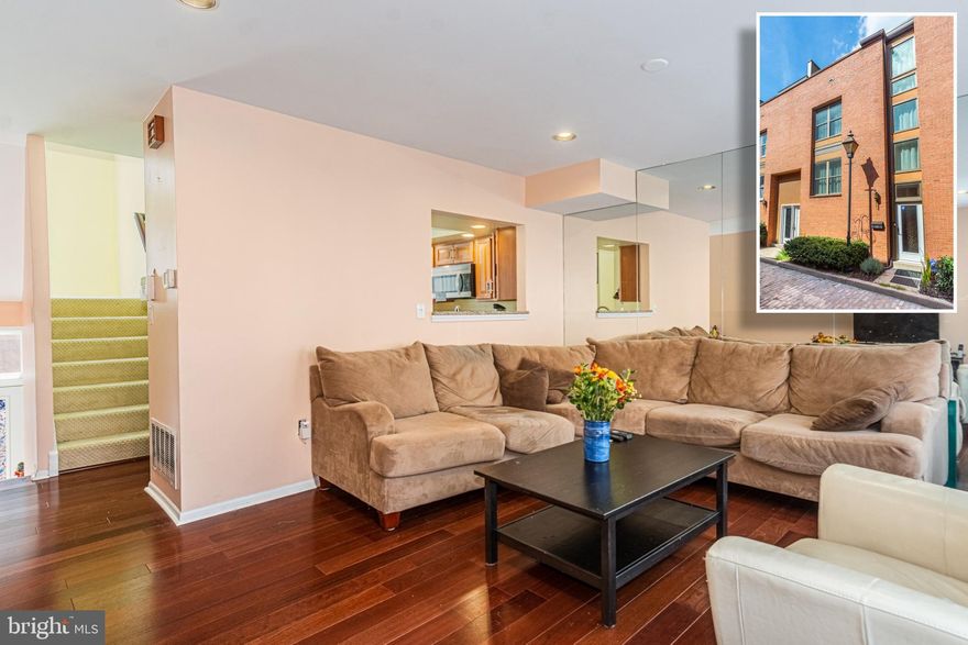 SUNNY & CHIC TOWNHOME WITH OVER 1,600 SQ. FT. OF LIVING SPACE AND COVERED PARKING!  This move in ready townhome features a spacious living room with hardwood floors, Chef's kitchen with granite counters, ss appliances, and a separate dining area, main level balcony, 2nd level with 2 generously sized bedrooms & 1 full bath, 3rd level with a 3rd bedroom, 2nd full bath, and a sundrenched sitting room that leads to the 2nd balcony, finished basement with a laundry area and half bath, and 1 car covered parking! Recent updates include new hardwood flooring, new windows and doors, custom closet systems, and a new roof to be installed within the next few weeks.  Location can't be beat - steps to community park and minutes from the Inner Harbor, stadiums, and Federal Hill restaurants!
