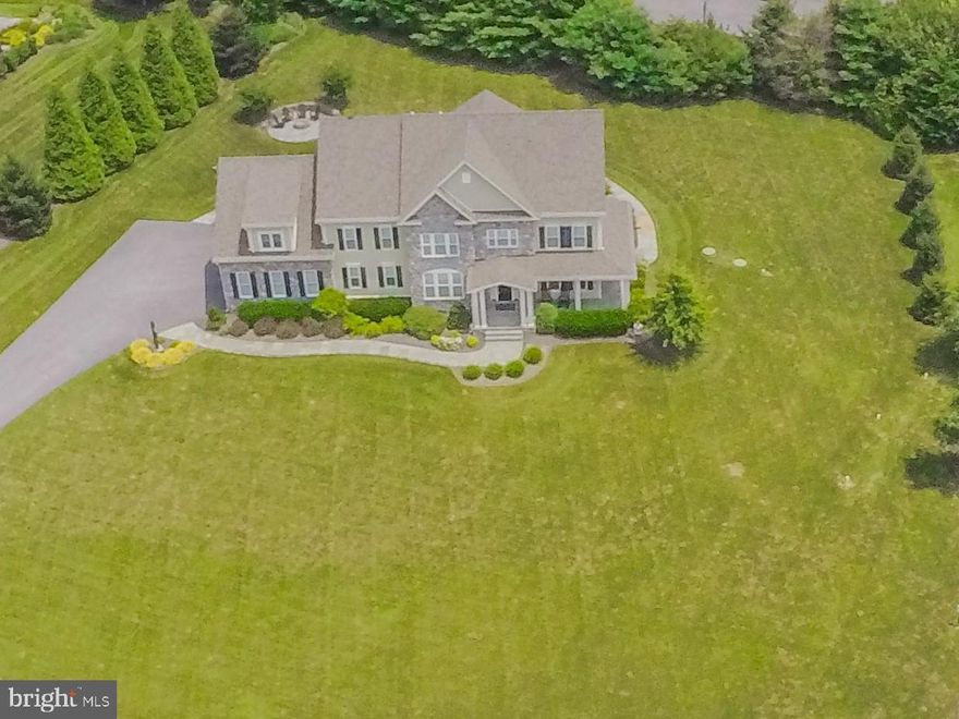 OPEN SATURDAY THE 13TH, COME SEE THIS GORGEOUS HOME!  This is the prettiest house in the area! Exquisitely executed custom home built with luxurious finishes and thoughtful attention to detail. This warm and  sophisticated home is "move in ready ." ***Bluestone pathways and a porch front welcome you home. The open concept living areas flow together with ease, yet there are many nooks and crannies for privacy and quiet. The hardwood floors, crown molding, tray, coffered and vaulted ceilings with recessed lighting all add to the ambiance of this home. *** The first floor office has built in shelving and windows to the front and side yard.*** Cozy up to the stone  gas fireplace in the family room while the chef's kitchen prepares a feast using the Jennair gas cooktop,  dual ovens, and massive granite island that seats 7. ***The breakfast area has table space and an additional bar for three. *** There is a shelved walk in pantry, a planning office with built in desk and a mudroom outfitted with cubbies. *** The first floor also features a complete guest suite, a powder room, and side door to the covered porch.***The second level has hardwood halls, linen closet, a large laundry room with closets and hanging space, and four large bedrooms.  the Master bedroom has windows to the rear,tray ceiling,moldings and  a large walk in closet.  the Master bath is surrounded in granite, as is the twin vanity. Fluted privacy glass on the shower and a separate WC add to the comforts.  ***Two of the bedrooms have an additional alcove nook sitting area, built in bookcases, and a walk in closet.  The bright front bedroom features a closet system and is currently being used as a craft room. ***There is a lovely area to lounge upstairs in an additional common area.*** The lower level is completely finished as one open L shaped space with a full bath.  There are two massive closet storage rooms, and a double wide walk up to the rear patio.*** Entertain on the stone patio with sitting walls and firepit for those chilly evenings or for s'mores in the summer. This house will not disappoint,  it is a joy! Previous Buyer financing fell through