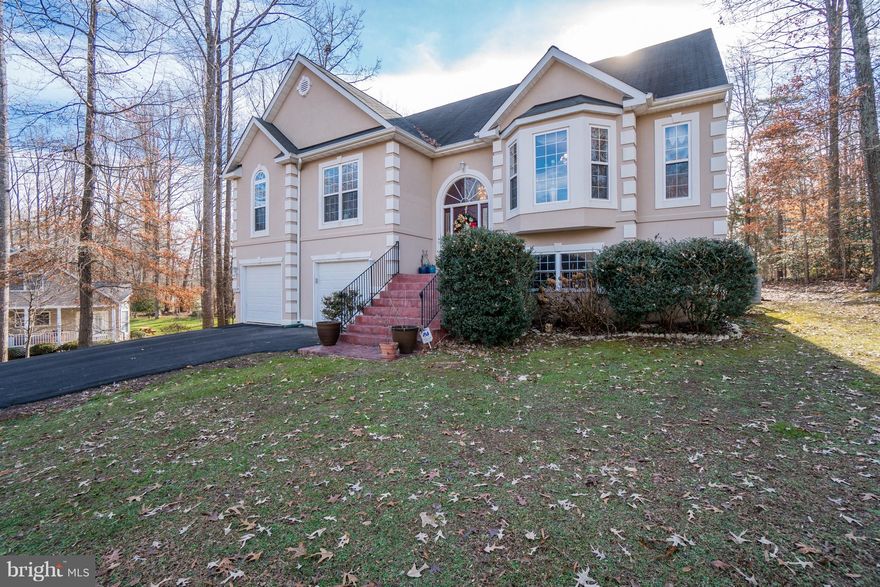 Colossal and stylish home in amenity rich Lake Land'Or! This amazing home offers well more than 3000 finished square feet of living space, as well as a sizable deck and a beautiful stamped patio.  5 bedrooms (3 bedroom septic perc) and 3 full baths, 2 family rooms, a game/recreation room and more, ensures that you have a mammoth amount of space to live and grow into this home.Size and beauty at this home isn't exclusive to the inside. The words "peaceful" and "serenity" come to mind as you stand on the back deck gazing across the neighboring farmland. And what a huge front yard! It's easy to imagine the play and recreation that is in the buyer's future in this front yard.The interior of the home will satisfy most any buyer seeking large living areas in a well designed and appointed home.  This is inclusive of things like hardwood flooring, vaulted ceilings a spacious formal dining room, a breakfast nook and an elegant master suite with a sitting room, soaking tub, double vanity and separate shower. That is all on the main level! And what about that basement though!! It is nearly like having a second house with additional bedrooms, a second family room, doors leading to the stamped patio and hot tub, and so much more. We haven't even begun to talk about the neighborhood.  This is one of the most amenity rich places to live in Caroline County, with two in-ground swimming pools, tennis courts, basketball courts, clubhouses, restaurant, beaches, skeet and archery ranges, campground and more.Are you still there? Or are you already on the phone with your favorite real estate professional trying to schedule an appointment?  Come see this one today!