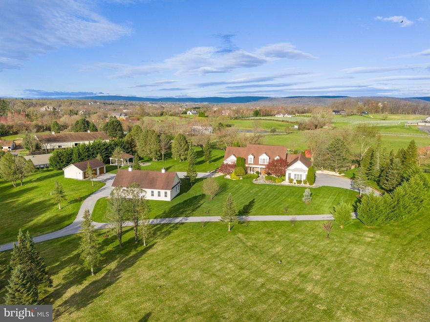Prepare to be blown away as we unveil the extraordinary 15901 Hampton Rd in Hamilton VA. This property is the epitome of perfection, offering everything you could possibly desire. Whether you're seeking main level living, a multi-generational setup, a poolside oasis, or a haven for car enthusiasts, this home has it all!

Step into luxury with the Main Level Primary Suite, boasting hardwood floors, dual walk-in closets equipped with custom closet systems, and a lavish spa-like bathroom featuring heated floors and a digital steam shower.

Indulge your culinary fantasies in the recently renovated kitchen by Stonegate Construction. This culinary masterpiece boasts top-of-the-line finishes, including custom cabinetry with inset doors and drawers, exquisite quartz countertops, and an appliance package that would make any chef weak in the knees. With Thermador appliances such as a 60” 6-burner gas stove with a 2-burner induction cooktop, Steam wall oven, 48” built-in refrigerator/freezer, built-in icemaker, 2 dishwashers, and a built-in beverage center, this kitchen is a dream come true. The expansive island is perfect for entertaining and is simply stunning. And let's not forget the spacious walk-in pantry!

The light-filled family room features a vaulted ceiling and cathedral windows, creating the perfect ambiance for gatherings. Meanwhile, the sunroom is equally charming with its wood ceiling, skylights with remote-controlled blinds, and panoramic views of the mountains, pool, and tranquil waterfall.

Upstairs, you'll find two generously sized bedrooms, each with updated en suite bathrooms and hardwood floors. The lower level offers a 4th bedroom with a separate exterior entrance, ideal for an au pair or in-law suite. Additionally, the fully finished basement includes a large rec room, convenient bar with another refrigerator, and a versatile flex space that walks out.

Outside, multiple Trex-type decks and patios beckon you to enjoy the saltwater pool and swim spa/hot tub. This home is designed for outdoor entertainment and fun!

If that wasn't enough, car enthusiasts will rejoice at the 3 car attached side load garage, complemented by an additional 3 car detached garage and a 2 car detached garage with a separate contemporary 1 bedroom apartment. That's a total of 8 garage spaces!

Conveniently located in Hamilton, this home offers easy access to major commuting routes, Dulles International Airport, and the plethora of shopping, dining, and amenities that Loudoun County has to offer.

Prepare to be wowed by 15901 Hampton Rd – it's more than just a home; it's a lifestyle!