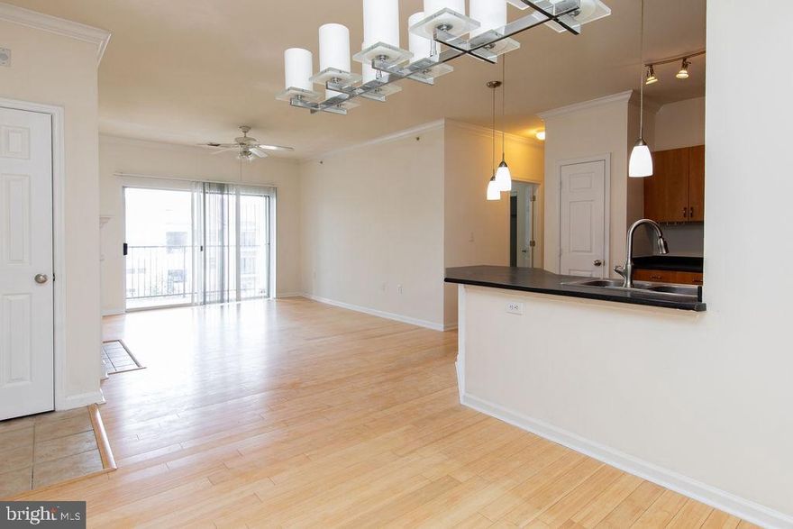 Lots of natural light fills this 2 bedroom 1 bathroom condo with spacious living area. Nice, open kitchen and dining room complete this spectacular space. Enjoy the morning sun or evening breeze on your deck.  Freshly painted walls.  Beautiful light shaded hardwood floors.  Just move right in!