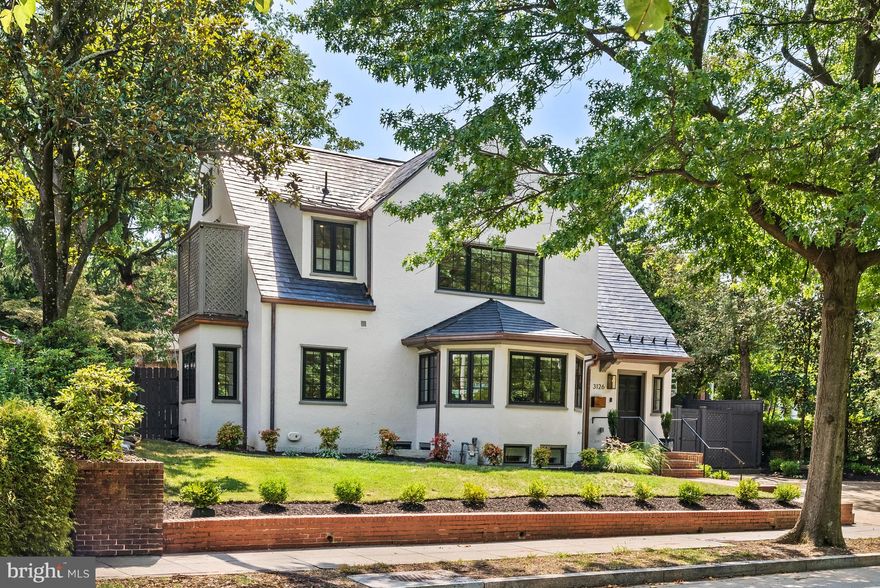Masterfully renovated in 2022 by Dilan Homes, 3126 Woodley Rd NW presents an exquisite 1923 Tudor-inspired home in the heart of Woodley Park. The re-imagined 5 Bedroom, 4.5 Bathroom, 4,600 SF home debuts an open-concept floor plan highlighted by abundant natural light, European wide plank white oak flooring, gorgeous moldings and designer fixtures throughout. The Main Level showcases effortless flow between its principal entertaining spaces, which include a sprawling Living Room, Dining Area, and Gourmet Kitchen with quartz countertops, Viking Appliances, custom inset cabinetry, a walk-in pantry, and direct access to a fully fenced and professionally landscaped, south-facing rear garden, dining patio, and Outdoor Kitchen. 3 Bedrooms, 2 Full Bathrooms, Laundry Closet, and an Outdoor Terrace are located on the Second Level. The privately appointed Primary Suite showcases a walk-in closet with built-ins, spa-like bathroom with double shower, dual vanity, separate water closet and balcony access. The Top Level, with rare views of the National Cathedral, holds the 4th Bedroom, a Full Bathroom, Sitting Room and Storage Space. The multifunctional Lower Level boasts a spacious Family/Recreation Room, Exercise Room, partial Kitchen, second Laundry Room, ample Storage, a 5th Bedroom and additional Full Bathroom. An attached, deep 1-Car Garage with storage space and 3 additional Surface Parking Spaces round out the numerous amenities this tremendous modern home has to offer.

Sited across the street from the beautiful woodland gardens and trails of Tregaron Conservancy and with easy access to Rock Creek Park, the Cathedral and Zoo, this luxurious property is close to some of DC’s most valued urban treasures. Also, within close proximity are five highly regarded private schools. The Woodley Park-Zoo/Adams Morgan and Cleveland Park Metro stations are just a few blocks away. The Connecticut Avenue and Wisconsin Avenue commercial corridors provide numerous restaurants and retail shops to residents.