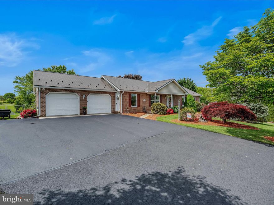 JUST LIKE NEW - This meticulously maintained ranch home boasts an abundance of tender loving care. Upon entering through the front door, you'll be greeted by the living room's beautiful hardwood floors. The expansive kitchen-dining room features oak cabinets and a Corian countertop, complete with a range, refrigerator, dishwasher, microwave, garbage disposal and pantry. Adjacent to the kitchen lies a spacious family room, ideal for family gatherings. The primary bedroom is complemented by an updated primary bathroom with a walk-in shower and a large walk-in closet. Additionally, there is a second bedroom and a full bath. The lower level offers a third bedroom, a vast recreation room with a propane stove for warmth, a partial kitchen, and a third full bathroom. This home is equipped with a heat pump.  Baseboard and propane stove heat in the lower level. Exterior features include a new metal roof, brick front, two-car attached garage, chain link fence, and a spacious rear deck. Situated on a beautifully maintained one-acre lot.