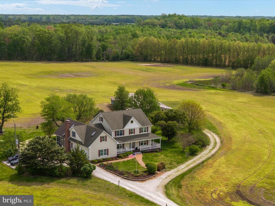 SELLER NOW OFFERING A $20,000 CREDIT TOWARDS FRESH PAINT & NEW CARPET. Back on the Market due to Buyer's FSA financing falling through. 
Welcome to Thanksgiving Farm, an exceptional opportunity to own nearly 100 acres of prime Eastern Shore farmland just minutes from charming small towns and within easy reach of Ocean City, Annapolis, and major airports. This versatile estate includes two parcels – one is a separate, buildable 13.81-acre lot, offering future flexibility or potential multi-generational living. Tucked at the end of a long private drive, the main home is a thoughtfully designed farmhouse that perfectly blends classic charm and practical living. The home features four spacious bedrooms upstairs, including a private primary suite with a sitting area, large bathroom, and direct access to a massive bonus room – perfect for a home office, yoga studio, sewing room, or playroom. The bonus room also has its own private staircase, making it a truly flexible space. On the main level, enjoy hardwood floors throughout, a light-filled kitchen that opens to a casual dining area and cozy family room with a wood stove. Just off the family room, a large screened-in porch overlooks the property’s picturesque fields, gardens, mature trees, and classic barn. A formal living room and dining room round out the main level, ideal for gatherings and entertaining. There’s also a convenient first-floor bedroom. The unfinished attic—with walk-up stairs, windows, and skylights—offers the potential for a bunk room, office, or gym, while the walk-out basement is ideal for a workshop or storage and connects directly to the attached garage. Outdoors, the land itself is the true star. Of the 99.81± total acres, approximately 70 are tillable—ideal for row crops or converting to a regenerative farm. Several low-lying areas create opportunities for duck ponds or managed impoundments. The remainder of the property is wooded and absolutely teeming with wildlife—whitetail deer, turkey, and more—making it a hunter’s paradise. A large equipment shed offers ample space for tractors, ATVs, RVs, boats, and anything else you can imagine. Whether you’re looking to work the land, create a multigenerational retreat, or simply unwind in the heart of Maryland’s farm country, Thanksgiving Farm offers endless possibilities.