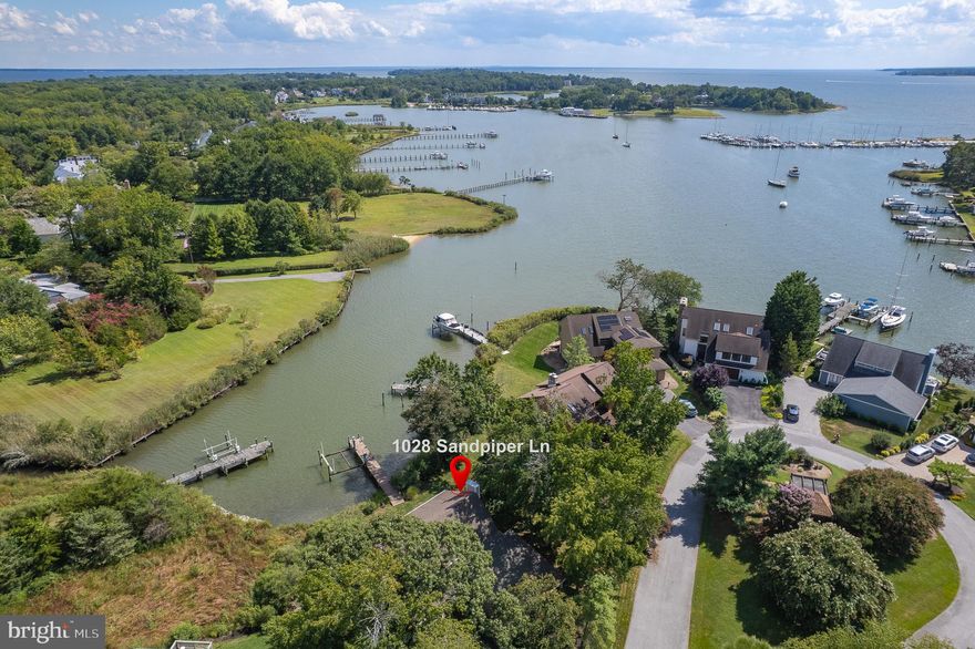 Stunning Waterfront Home with Private Pier and Direct Access to the Chesapeake Bay! This beautiful waterfront property is one of only 16 homes in the exclusive Quay Harbor community. Residents enjoy amenities like a tennis/pickleball court, overflow parking, a central gazebo, and a private, tree-lined entrance.  The home offers tranquil water views and a private pier equipped with a 12,500 lb boat lift, water, and electricity—just minutes by boat from downtown Annapolis. Lovingly updated by its current owners, this home perfectly blends comfort, quality, and coastal charm.  Key Features Include:  
Hardiplank siding and a 2-car garage, New Carrier Infinity Series 4-ton heat pump (2024), Brazilian Cherry hardwood floors and remodeled baths, Updated kitchen with water views and stainless steel appliances, including a double wall oven, microwave, warming drawer, gas cooktop, dishwasher, and a reverse osmosis system for drinking water.  Kitchen opens to a relaxing deck with an awning, perfect for enjoying water views.   Family room with gas fireplace and water views and deck access!  Two-story foyer and open living and dining rooms! Convenient main-level laundry room! Upstairs, the spacious owner’s suite features vaulted ceilings, a walk-in closet, an updated bath, and additional storage. Start your mornings on the private waterfront coffee deck—an ideal spot to watch the sunrise.  The home is fee simple and seller maintains home, yard, and pier.  Condo association maintains road, sewer, tennis courts, extra parking and gazebo.  Nestled on a quiet cul-de-sac in a picturesque community, this home offers the perfect combination of peaceful living and easy access to all that Annapolis has to offer.  Convenient to Baltimore, Washington DC, Ft. Meade, and Andrews AFB too!