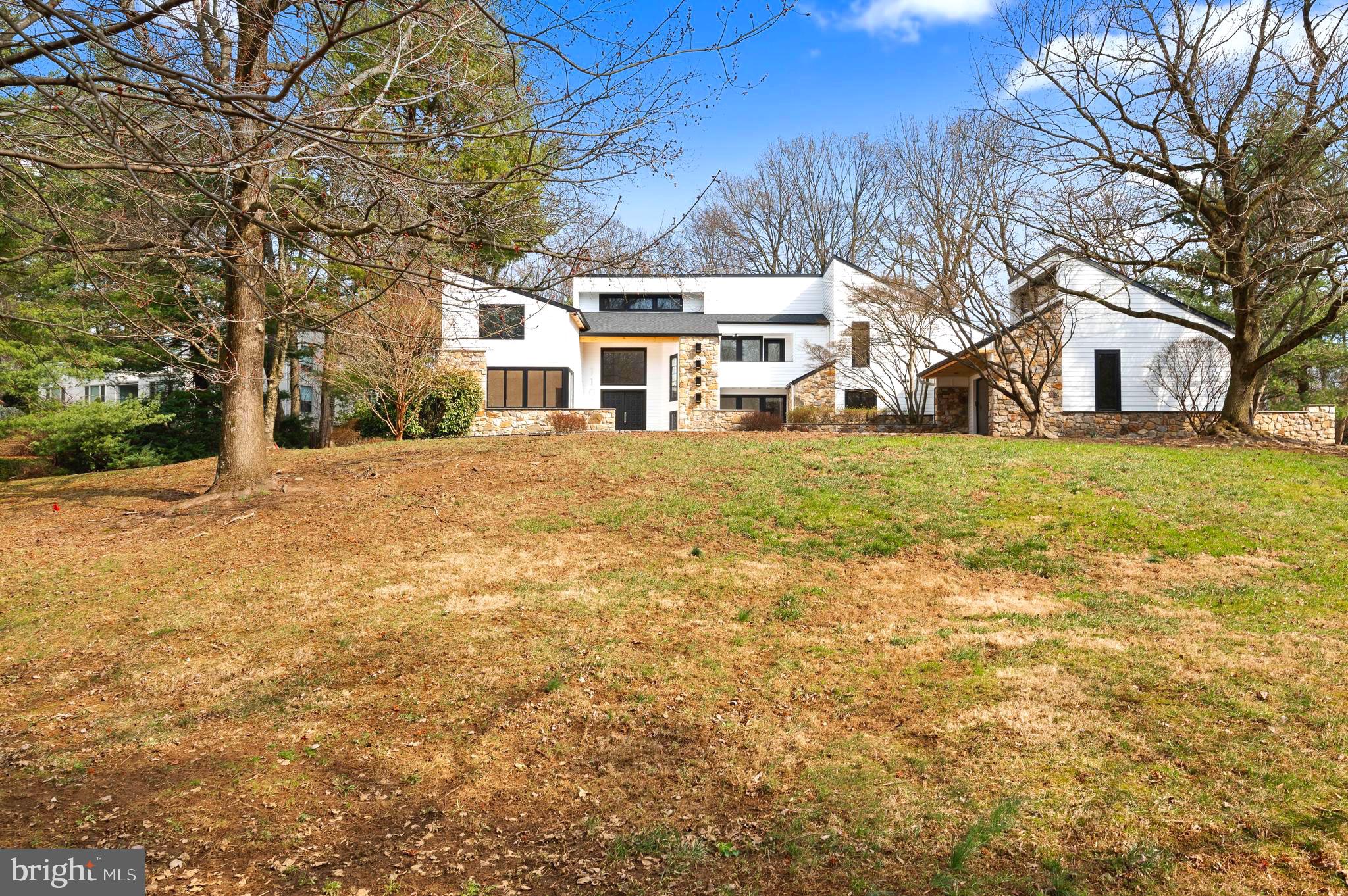 This stunning transitional contemporary-style home, located on a highly desirable cul-de-sac street of northside Bryn Mawr, has just been completely and magnificently renovated. Boasting the latest trending color palette, wood accents and gorgeous finishes, this home is a feast for the eyes. The 2-story entry opens to a spacious living room featuring floor-to-ceiling windows that offer breathtaking views. A large dining room with views of matching fireplaces completes the central portion of the home. The formal living room, located on the left side of the home, to the private home office, powder room, coat closet, and 1st floor primary bedroom. This luxurious primary suite includes vaulted ceilings, bedside reading lights, custom built-ins, and private exterior access. Its attached Japandi bath is designed to rejuvenate your body and spirit. Entering from the garage, you will find a large mudroom, an overflow closet, stacked laundry room, and a full bath. The second floor is finished with hardwood flooring throughout. Another private primary suite is on this level, complete with a spacious en suite bathroom and dual closets. Bedrooms 3 and 4 share a Jack & Jill bath customized with a private shower. Bedroom 5 includes a private bath as well as a cedar closet. A second laundry room completes this level. The larger portion of the lower level is finished with waterproof vinyl flooring and a full egress window. The inground swimming pool has new plaster and tiling, an attached hot tub, and is surrounded by beautiful flagstone and landscaping. The location is close to award winning schools, great shopping, dining, and all major transportation routes.