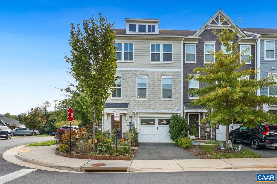 Welcome to this stunning four-bedroom, three-and-a-half-bath end-unit townhome, filled with natural light and breathtaking mountain views. The first floor features one of two primary bedrooms with a walk in closet, ensuite bath and patio access. Sleek LVP floors and an open-concept layout make living and entertaining effortless. The gourmet kitchen boasts a large eat-in island, pendant lighting, recessed lights, and stainless steel appliances, flowing into the dining area and living room with a private deck. Upstairs, the second primary suite offers a spa-like bath and walk-in closet, while additional bedrooms provide comfort and versatility. The fourth-floor loft is a retreat with a balcony overlooking Carter and Brown Mountains and Fourth of July fireworks. Enjoy a one-car garage, driveway, and guest parking. Conveniently located adjacent to the fitness center and tot lot. Enjoy a friendly neighborhood with community events throughout the year. Perfectly located just minutes from downtown Charlottesville, the pedestrian mall, and the shops and restaurants at 5th Street Station.