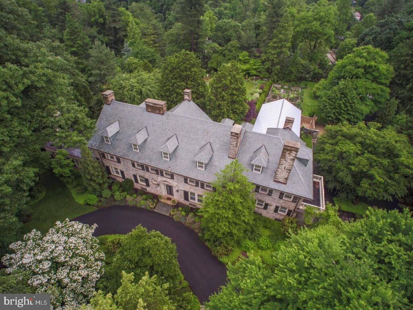 We are proud to offer a Chestnut Hill Premier Property built in 1907, designed by Zantzinger & Borie, architects for famed buildings in D.C. and Philadelphia, including a carriage house and greenhouse. Situated on 2.87 acres, the fully restored gardens were designed by Frederick Law Olmstead's firm and recorded in the Smithonian. Specimen trees are a collection from China and a portion of the acreage is protected by a historic easement from the Chestnut Hill Historical Society. Enter through a foyer into the large entry hall with a carved terra cotta fireplace. From here: a direct expansive view of the formal gardens. Other first floor rooms are elegant library/office with fireplace, offering a retreat from the otherwise expansive spaces. Fireplaces also grace the large formal living and dining rooms. Other first floor rooms of generous sizes are formal living and dining rooms, den with shelves and door to pool area. Spacious eat in kitchen with large center work space of inlaid granite, top of the line appliances, expanding to a butler's pantry with second refrigerator/freezer and wine cooler. Two powder rooms, laundry room. An expansive garden room with three directional views includes a fully equipped kitchen and full bath. Second floor offers two Master bedroom suites plus four additional bedrooms and 2 additional full bathrooms. Third floor has five rooms, some equipped with office built-ins, and 1 1/2 baths. Floors are hardwood and solid pine. Marble and tile floors in all bathrooms, crown moldings in most rooms. Family vacated the house for 5 years (2004 to 2009) for a complete renovations of all systems. Slate was mined in Vermont for roofs of the main house and the carriage house. Flagstone side walk and stone curbing around the perimeter of Seminole Street and West Chestnut Hill Avenue. Carriage house (8709 Seminole St,) renovated in 2016, includes a fully equipped eat in kitchen, large living room, two bedrooms, small office, 1 1/2 baths. Greenhouse (60x16) was rebuilt to original design and is operated by a computerized system for heat and humidity in a basement below. Adjoining the greenhouse is a potting shed and half bath. All structures are stone and glass. Zoning for 8709 is RSA3, for 8711 is RSD1 and WWO overlay district. Note: Carriage House: 2,100 interior sq. ft.0.31 acres, Taxes for carriage house are $11,162. Copy of Conservation and Preservation Easement shall be provided to buyer before entering into an agreement of sale.