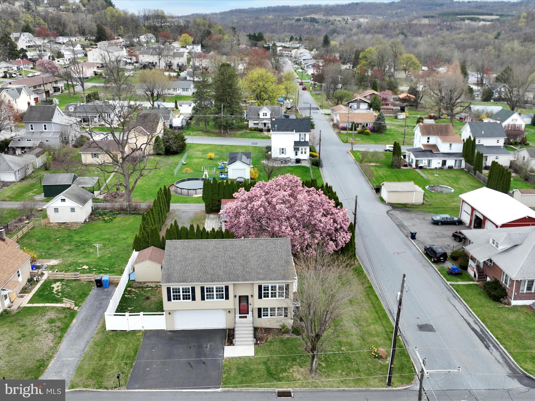 The pink tree marks the spot! This impeccably maintained bi-level home blends style, comfort, and convenience in a peaceful residential setting with beautiful views. Ideally located just minutes from parks, restaurants, shopping, the new Giant grocery store, and Route 145, this property offers the perfect balance between tranquility and accessibility.
The home features 3 generously sized bedrooms and 2.5 bathrooms, with an open-concept floor plan designed for modern living. Thoughtfully upgraded, the home includes luxury vinyl plank flooring throughout the main living areas, refinished stairs, and a custom-stained deck. Additional enhancements include a brand new $10,000 vinyl fence, garden shed, raised garden beds, updated landscaping, and upgraded lighting with modern energy-efficient LED fixtures.
Smart home features such as a Ring doorbell and smart thermostat offer added comfort and security. The kitchen is accented by a tile backsplash, while upgraded trim, custom closet systems, and pre-wired audio jacks for surround sound elevate the home’s function and style. The interior has been professionally repainted in a contemporary, neutral palette to suit a variety of tastes.
An oversized two-car garage offers ample storage and includes a finished interior, automatic opener, and exterior keypad access. With a great yard and well-appointed finishes throughout, this home is move-in ready and a true standout in today’s market. Book your showing anytime!