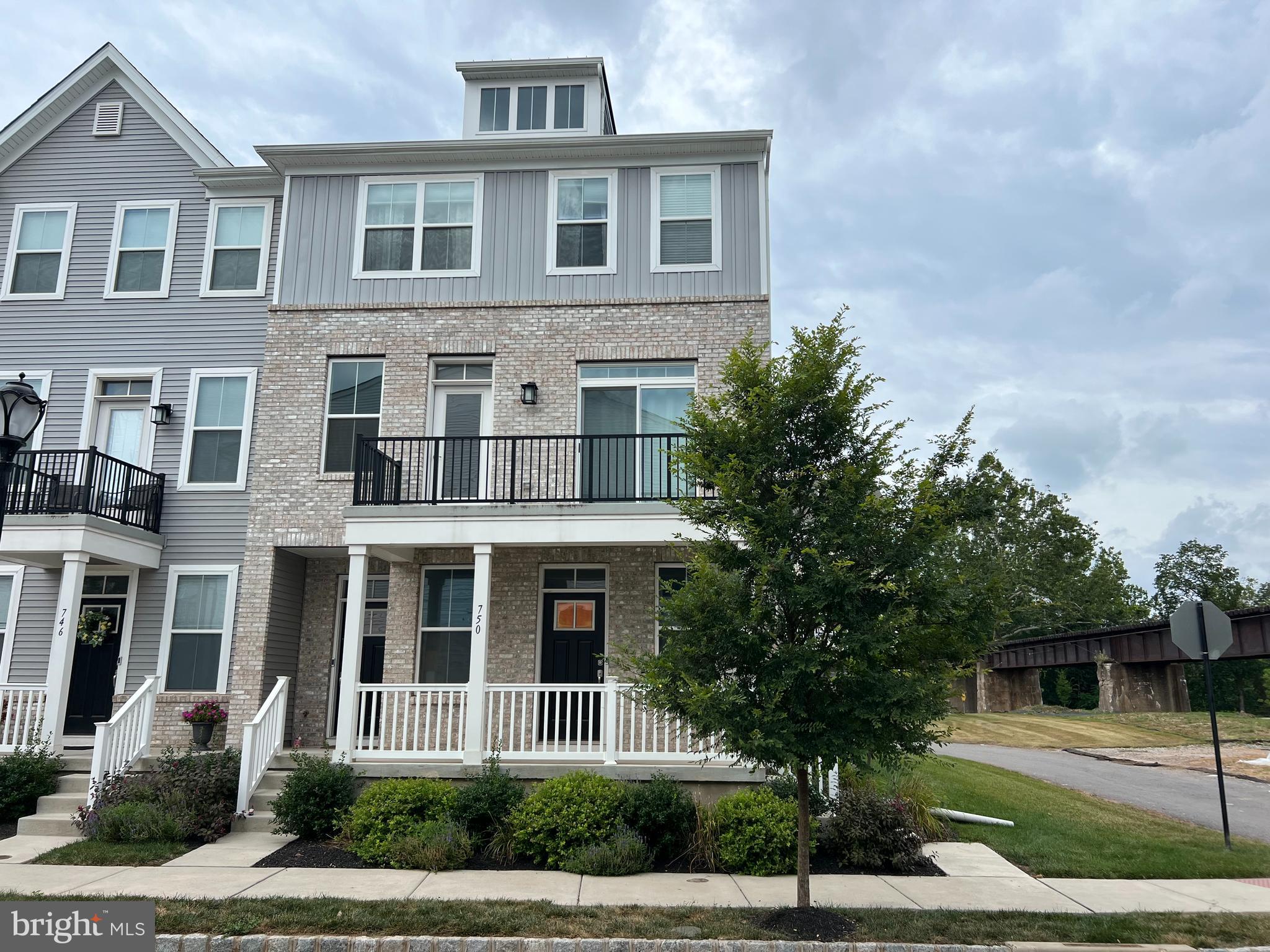 Welcome to Steelpointe, one of Phoenixville’s most desirable communities! This stylish, 3-year-young end-unit townhome offers the perfect blend of low-maintenance living and modern design—all within walking distance of vibrant downtown Phoenixville. From the moment you arrive, the brick front façade and charming covered porch create instant curb appeal. Step inside to an open-concept layout with 9’ ceilings and wide-plank flooring that seamlessly connect the spacious great room and kitchen. The kitchen is a chef’s delight, featuring 42” cabinetry, quartz countertops, a gas range, stainless steel appliances, an oversized sink, and built-in microwave. A convenient powder room, pantry/storage closet, and indoor access to your oversized one-car garage complete the main level. Upstairs, you’ll find two bright bedrooms that share a beautifully appointed bathroom with a double vanity, tile flooring, and tiled shower surround. A stackable washer and dryer are conveniently tucked into the hallway. Both bedrooms offer access to a spacious balcony—perfect for relaxing with morning coffee or evening sunsets. Additional highlights include a private driveway, plentiful guest parking, and access to the Schuylkill River Trail right at your doorstep. Enjoy weekend strolls along the riverfront trail or take the pedestrian bridge into town for boutique shopping, entertainment, and countless dining options. With easy access to Center City, major corporate centers, and commuter routes, the location can’t be beat. This home offers modern comfort, unbeatable convenience, and a sought-after lifestyle in the heart of Phoenixville. Don’t wait—schedule your showing today!