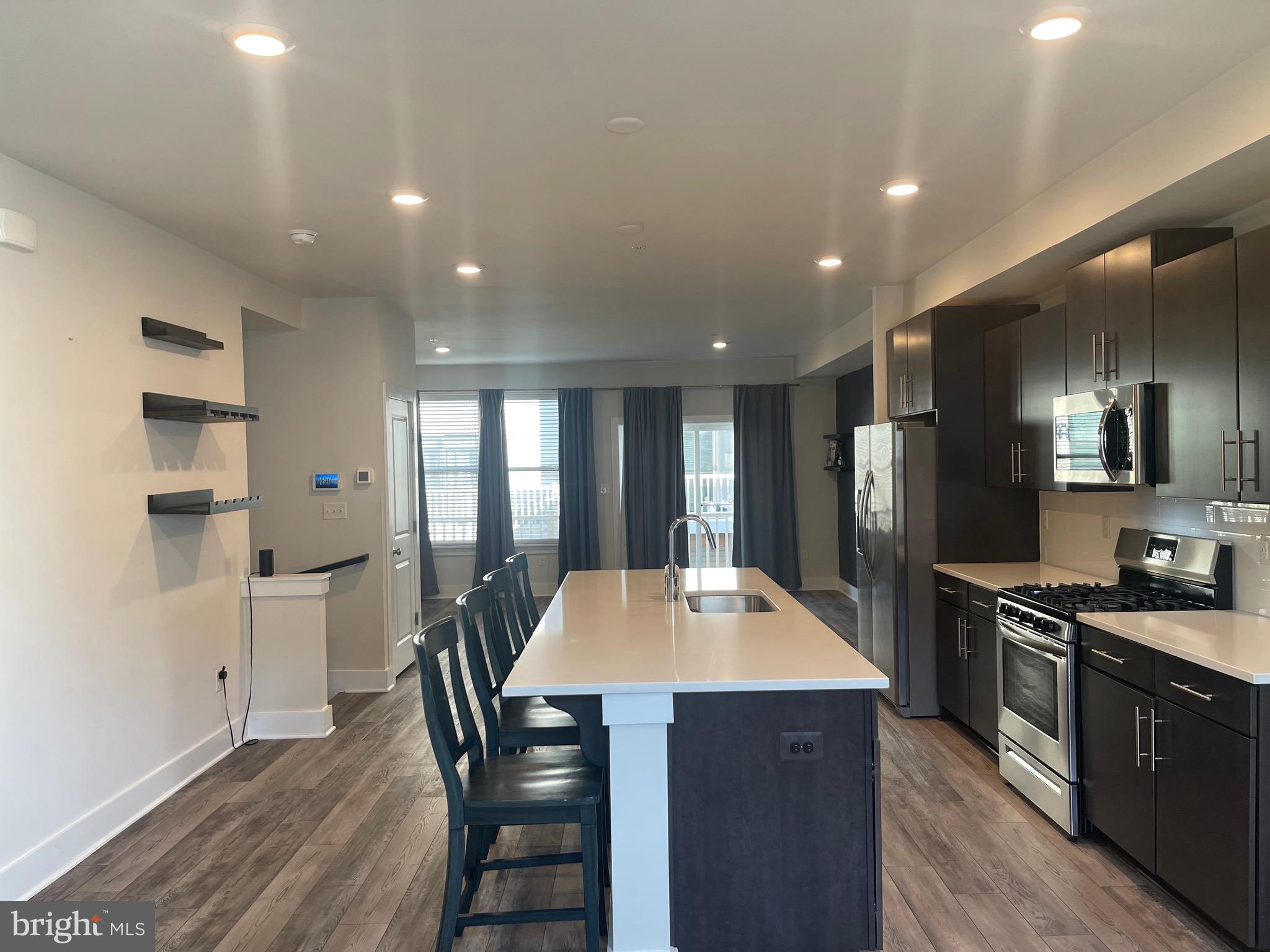 Located in the Roland Heights Community, this contemporary-style, 3bd 2.5 ba townhouse has an open floor plan which boasts a modern kitchen w/ stainless appliances, a 7ft long quartz island, custom cabinets, and shelving. It also features hardwood flooring, a spacious family room, a separate dining room, w/d, and garage parking (2). The townhouse is zoned for Medfield Elementary (just 2 blocks away), and Baltimore Polytechnic Institute and Western High School are within 1 mile. There's a public 10-acre park with baseball diamonds, a basketball court, and playgrounds for play. Foodie Alert! Within 1 mile are at least 25 fantastic restaurants, the unique shops in Hampden, and the Union Collective (coffee, gym, brewery). If you want to head downtown for the nightlife and cultural activities, it's just an 8-10 minute drive.