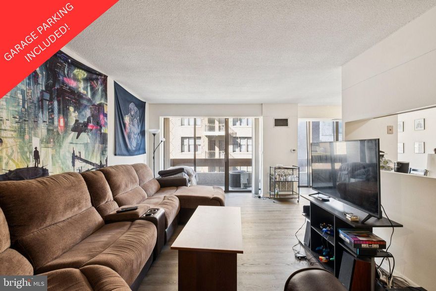 Spacious two bedroom, two bathroom with a balcony at Center City One along the Avenue of the Arts. This home includes an uncovered parking spot ($60,000 value!) in the building's attached garage. Boasting city skyline views from all rooms, Unit 703 offers a split open floor plan ideal for both entertaining and everyday living.  Upon entertaining you are welcomed into a large living room with a private balcony. There is an adjacent dining area open to both the living room and kitchen with a Juliet balcony. The kitchen has a very functional layout with its generous cabinet and counter space (image shown of the kitchen is rendering of what it can look like with a minor renovation). The spacious primary bedroom has a walk-in closet and a marble-appointed ensuite bathroom with a stall shower. The second bedroom has a wall of closets, walk-in closet and use of a marble-appointed full hall bathroom with white cabinetry. There is a side by side washer and dryer in the unit. Residents of Center City One enjoy a 24 hour doorman, on-site management, an attached parking garage, premium location along the Avenue of the Arts, and the convenience of ground floor retailer including a dry cleaner and convenience store.