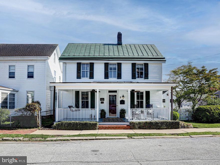 Step into a storybook at 8 Crawford Street, where history, charm, and modern luxury intertwine in the beloved “Schreitz House,” circa 1879. From the moment you arrive, the freshly painted exterior, cheerful green shutters, and a welcoming front porch complete with a classic porch swing set the tone for something truly special. It’s the kind of home that feels like it belongs in a novel, yet lives beautifully in the present. Surrounding the home, thoughtfully curated gardens burst with native greenery and vibrant blooms, creating a picturesque, low-maintenance landscape that evolves with the seasons. Whether you’re entertaining, unwinding, or simply taking it all in, every inch of this property feels intentional, peaceful, and alive. Inside, the original hardwood floors carry the legacy of the home through the formal living and dining rooms, spaces that feel both timeless and inviting. Just beyond, the heart of the home reveals itself in a stunningly renovated kitchen, where luxury meets craftsmanship. Outfitted with exquisite cabinetry, marble countertops, a classic subway tile backsplash, professional-grade appliances, an apron-front sink, and a beautifully centered island, this space was designed to gather, create, and impress. Tucked just off the kitchen, a convenient half bath and laundry area blend seamlessly into daily life, while the sunroom addition steals the show. Bathed in natural light from oversized windows, it offers the perfect place to sip your morning coffee, dive into a good book, or simply admire the lush backyard beyond. Outside, the magic continues with a thoughtfully designed retreat featuring a patio, fire pit, two sheds, and a charming playhouse, each element adding to the home’s enchanting personality. Upstairs, the story continues with more original hardwood flooring, three uniquely styled bedrooms, and a beautifully appointed full bath featuring detailed tile work, rich wood trim, and an antique vanity that feels like a piece of art. A walk-up attic offers additional storage and a whimsical dressing space tucked within, another nod to the home’s character and charm. All of this, perfectly positioned in the heart of Middletown, just moments from local favorites like Silver Lake Park, Appoquinimink Community Library, dining along West Main Street Middletown, and convenient access to Rt. 1 and Rt. 301 for effortless commuting. This is more than a home - it’s a feeling, a piece of history, and a place where everyday life feels just a little more magical. If you’ve been waiting for something that speaks to you - something rare, soulful, and unforgettable... this is your moment. Take the leap, homes like this don’t wait for long.