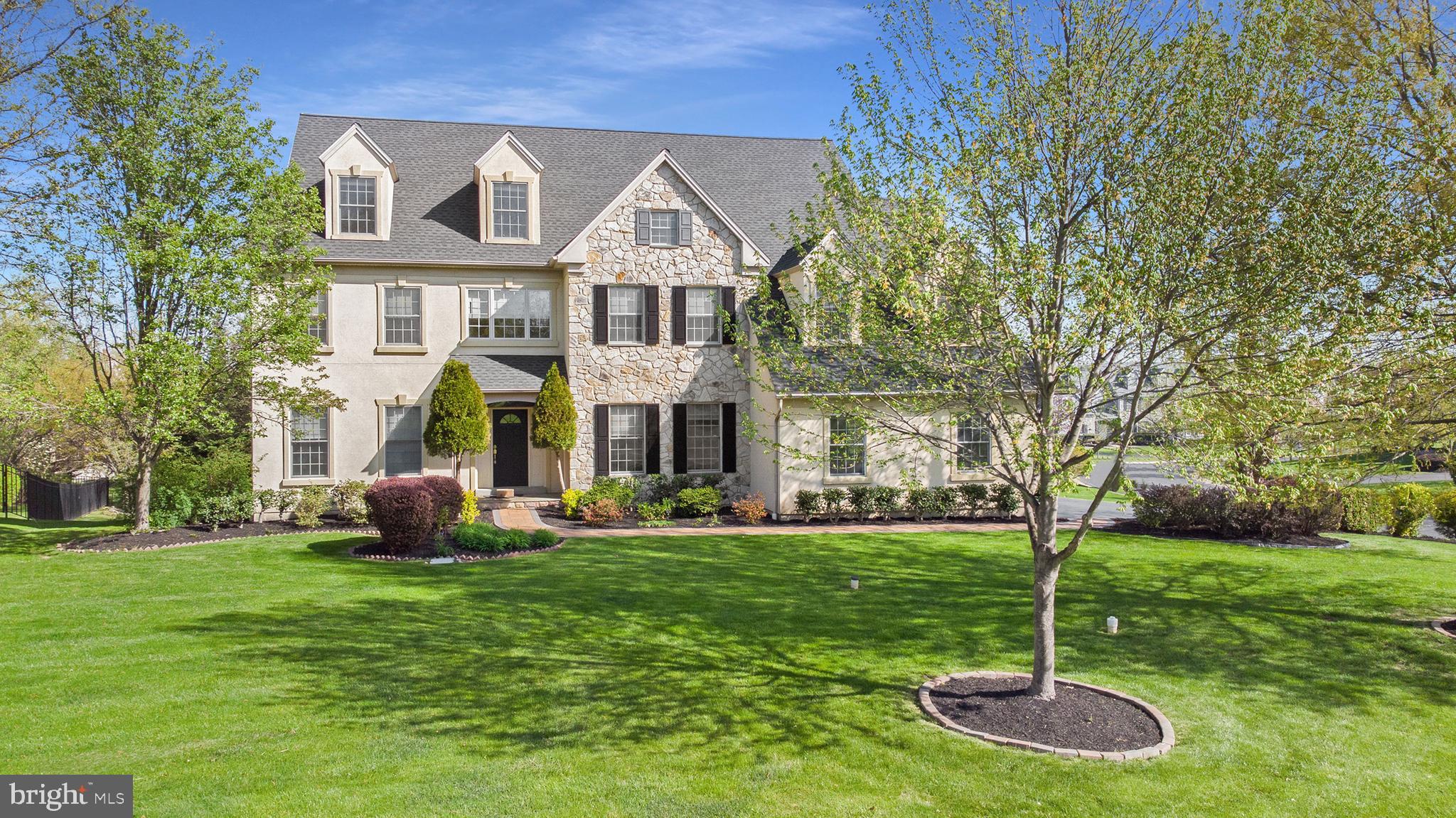 Breathtaking, executive home boasting top-notch features, 4 bedrooms, 3.5 baths, a huge bonus room, and over 4,500sqft! From the moment you arrive you will notice the perfectly designed and maintained landscaping and inviting walkway that leads to the covered front porch. Head inside to find a magnificent 2-story entrance with a chandelier, gorgeous hardwood floors that extend throughout entire house and a grand staircase that leads to the second level. An oversized Formal living room sits to the left of the foyer and has crown molding, bright windows and leads to the formal dining room that easily holds a table with chairs and a China hutch. Head in the kitchen where you will find recessed lighting, a large center island with seating space, pantry, and upscale light fixture, trendy tile backsplash, stainless appliances, built-in double ovens, and ample cabinet and counterspace sure to please any cook. Adjoining the kitchen is an eating area hosting a slider to your back deck overlooking your peaceful lot. A cozy family room offers a vaulted ceiling with skylights, a grand stacked stone, floor to ceiling fireplace, and a second set of stairs to the 2nd level with an open view of the living room below. French doors lead to your designated workspace for the ultimate work from home experience. A half bath with a pedestal sink and the laundry room completes this level. Double doors lead to the master suite boasting a coffered ceiling, hardwood floors, and a separate sitting or dressing room. The luxury master bath is sure to please and includes dual vanities, one is a make-up vanity, under cabinet storage, a jetted tub with a handheld sprayer, a linen closet and 2 walk-in closets. 3 additional guest bedrooms are bright and have double door closets. Enter the 2nd full bath through double doors which shines with an extended counter and dual sinks, under cabinet storage, and a linen closet, A 3rd full bath has a transom window for natural light. Take the catwalk to a short set of steps that lead up to the expansive bonus room with endless possibilities! The full walk-out basement has a sliding door that leads to the perfectly manicured lawn. Additionally, you will appreciate the 9ft ceilings on the main floor and basement, 3-zone AC/Heating, the attached 3-car garage with storage space, lawn irrigations system, and a lovely Gated community with walking trails and ponds. The stucco was replaced by the current owner and has sensors under the windows to test the moisture content with a meter that the seller will leave for the next owners peace of mind. Located in Blue Bell with easy access to shopping, restaurants, and, and entertainment! Award-Winning Wissahickon School District!