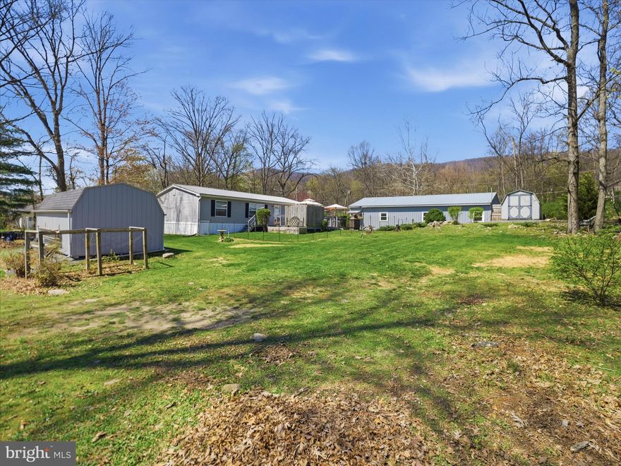 Welcome to this beautifully maintained ranch-style home, situated on a scenic 0.75-acre lot in the peaceful countryside with mountain views all around. Offering 3 bedrooms and 1.5 baths including a newly updated walk-in shower, this home combines comfort & charm! Inside, you’ll find a spacious open-concept layout connecting the kitchen, living, and dining areas, creating an ideal space for everyday living and entertaining. The kitchen features abundant cabinetry (new), generous counter space, and updated appliances, making it as functional as it is inviting. Washer and dryer are included for added convenience.

BUT WAIT!!! The true showstopper of this property is the incredible 3-bay garage—perfect for car enthusiasts, hobbyists, or anyone in need of year-round workspace. With a new pellet stove in 2024, this is the perfect hang out spot! Whether you're working on vehicles, storing motorcycles, or tackling projects, this versatile space offers endless possibilities. In addition, the oversized RV carport provides even more room for recreational vehicles, trailers, or additional storage. Outside you'll find a large deck for entertaining with a tiki bar and permanent canopy. A spacious yard makes this the ideal place for friends!

Lovingly cared for and meticulously maintained, this property offers a piece of mind that is hard to come by. With a newer metal roof, new heat pump and so much more, you'll be worry free for years to come. Be sure to ask for the list of updates! Opportunities like this are rare - don’t miss your chance to make it yours!