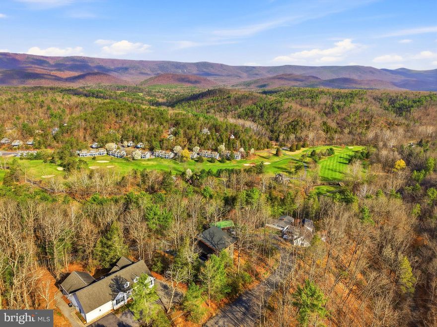 New Price! "Greenview Landing" Mountain Elegance with Versatile with 2 Living Spaces. Nestled in the heart of the mountains, this home offers a rare blend of contemporary design and alpine serenity. Permitted for 5-bedroom short term rental with the county. Spanning three thoughtfully designed levels, the residence is as functional as it is stunning. The lower level lives like a private apartment, complete with its own entrance and parking area, full kitchen, living and dining area, bedroom, full bath, and laundry hookups—ideal for guests, extended family, or rental potential. A covered patio adds a quiet outdoor retreat. Upstairs, the main level welcomes you with custom floors and sleek modern fixtures throughout. The open-concept kitchen, living, and dining area is anchored by a striking electric fireplace and flows seamlessly onto a covered deck—perfect for entertaining or unwinding with mountain views. Two spacious bedrooms each feature en-suite baths, and a stylish half bath and full laundry room round out the floor. The top level offers two additional bedrooms and a full bath, providing ample space for family, work-from-home flexibility, or creative use. There is an area for storage also! An oversized two-car garage and a gently sloped driveway with generous parking make mountain access effortless. This home is a rare opportunity to enjoy the tranquility of mountain living without sacrificing modern comfort or convenience. Seller to offer one year warranty valued at $600.00. Property comes with state of the art video surveillance monitoring system. Floors are Bruce Natural Hickory and siding is NDX premium vinyl siding. Bryce Resort is 7 minutes away and offers the following: small airport, library, dog park, indoor pool, outdoor pool, lazy river, pickleball, tennis, playground, 18 hole golf, course, mini golf, lake, mountain biking, skiing, snowboarding, ice-skating rink, and restaurants. 1.5 hours from NoVA. There is a farmers' market on Wednesdays during the summer. Call now for an appointment.