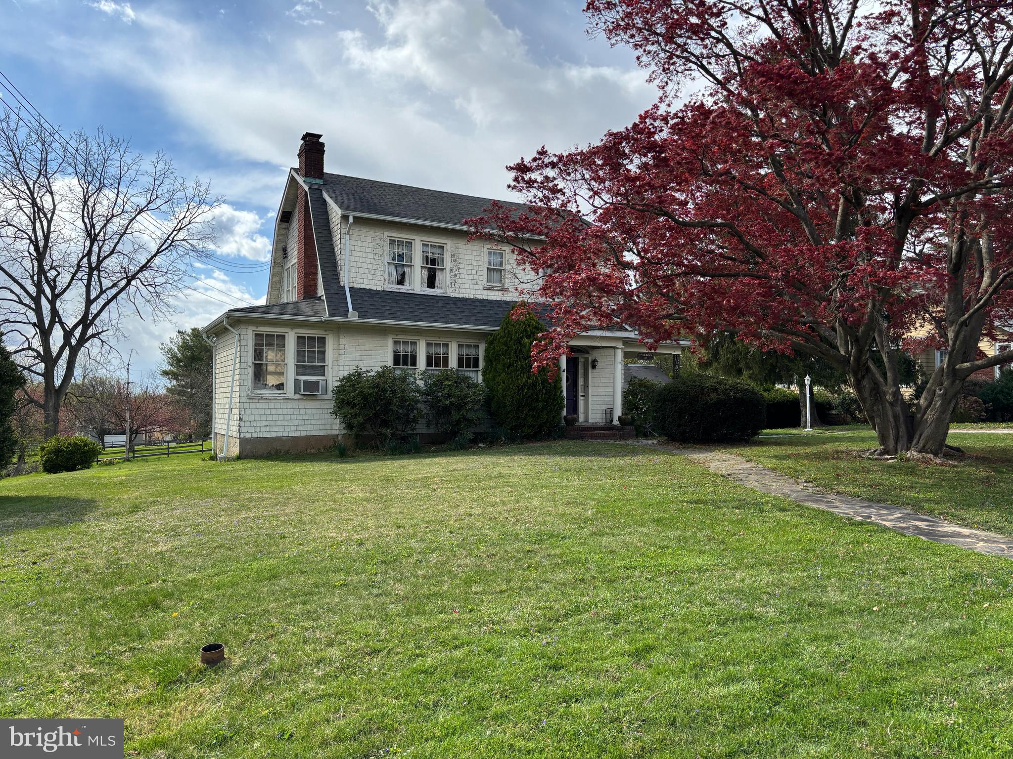 What an amazing opportunity to get into a single-family home in a great location!! This custom-built home is in the American Foursquare style, with Dutch Colonial Revival influences, and has so much charm! It has been lovingly cared for over many years by only two owners and it is ready for its third. Walk into the home's side porch and you are in a lovely, spacious foyer. You'll immediately notice the beautiful patterned wood floors, arches, and ornate wood staircase. The foyer leads into a generous family room with fireplace, which offers ample space to entertain and spend family evenings together. At the end of the house you'll find an office, with features ample light and a cozy spot to get work done. Or continue through the family room and you'll find a large dining room, also with lots of natural light. This flows into the kitchen. Behind the kitchen a full bath has been added, so there is a full bath on both of the main floors. Head upstairs and you'll find four bedrooms and a full bath, and up another level there is a roomy attic that could be insulated and made into additional living space. Back on the main floor, there is a rear entrance that leads into the back mudroom from the backyard, and there are steps down to the unfinished basement, which offers lots of space for storage. The lot is roomy, almost half an acre, and has plenty of space to play or garden or relax. The backyard also has a detached garage perfect for storing lawn tools and the like. You'll be close to all sorts of shopping and dining in Glyndon and Reisterstown, and can also quickly go north to Hampstead and Westminster, or south to Owings Mills and Baltimore, from this location. Showings will be extremely limited, on May 3 and 4 initially, so please make plans to come see it then!
(The home is being sold "as is", as the sellers are elderly and are unable to make any repairs).