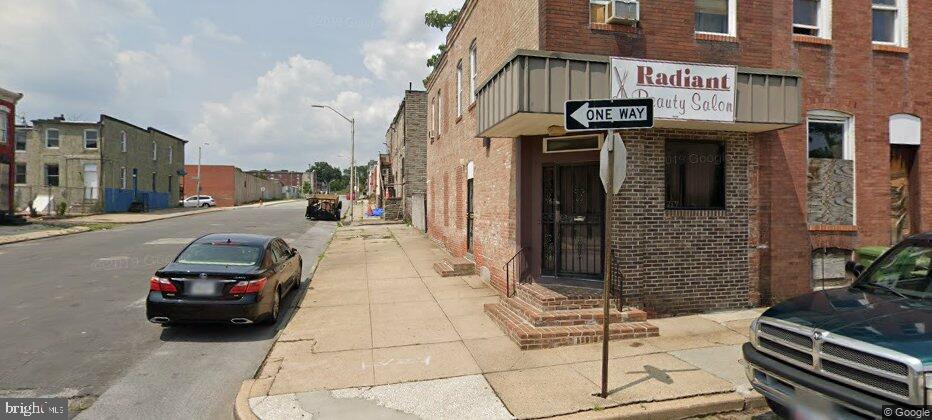 End unit corner of Prentiss Place and N Collington Ave 1st floor is an operating Beauty Salon, 2nd floor apartment. Very close to Hopkins. Being sold AS IS.