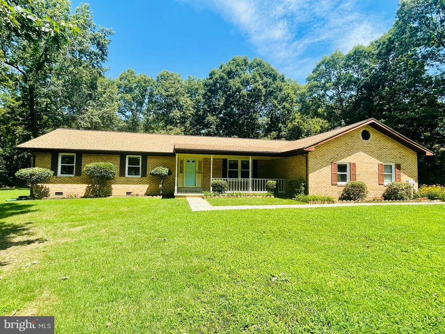 PRICE IMPROVEMENT! Beautiful MOVE-IN READY 1-level ranch/rambler home situated on over a 1-acre flat lot in a well-established, quiet neighborhood within close proximity to nearby shopping and restaurants. This home offers 3 bedrooms, 2.5 bathrooms, oversized 2 car attached garage with ample storage cabinets, three-seasons room connected to the family room, covered front porch, brick fireplace in the family room with beautiful hardwood floors, and encapsulated crawl space. The master suite includes an attached bathroom with large jacuzzi tub and walk-in closet. The full bathroom off the hallway features a walk-in bath tub. This home features a fresh NEW coat of paint throughout, NEW carpet, NEW vinyl flooring in the foyer, new central air condition system, and refreshed landscaping. Home is conveniently located for easy access to nearby military bases and commuter lots into Washington DC.
