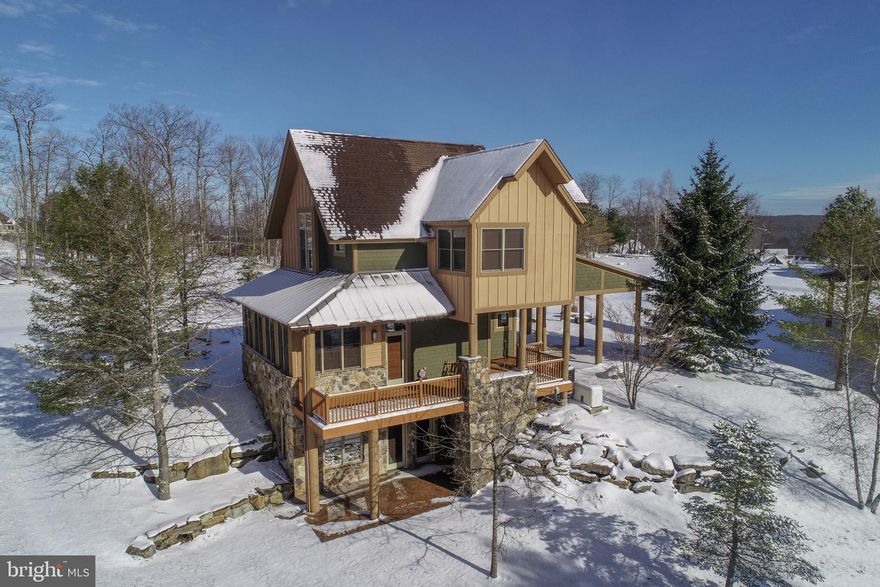 Luxury Mountaintop Ski Chalet with scenic Deep Creek Lake Access for year-round enjoyment. Just minutes from Wisp's ski slopes and ASCI Whitewater, this fantastic location is ideal for exciting summer adventures and winter skiing with effortless connections to the Ski Lodge, Wisp's easy-access mountaintop parking area, lift tickets, on-site community amenities, and everything you need. Exceptional craftsmanship and upscale finishes shine throughout this home's bright, open layout designed for entertaining. Unwind by the striking stone fireplace in the inviting living room, while a generous family room and sunlit, flexible loft provide ideal spaces for entertaining, relaxing, or hosting guests. Three bedrooms and 3.5 baths across three beautifully designed levels deliver comfort, privacy, and room to gather. A convenient double carport adds everyday ease for owners and visitors alike. Surrounded by lush, thoughtfully landscaped trees, the setting offers a quiet mountain ambiance with filtered woodland views, and a true resort-style retreat feel. Designed for four-season mountain living, this home offers a high-efficiency HVAC system, architecturally-enhanced cylindrical exterior columns for long-term resilience, and tastefully updated interior and exterior paint—combining luxury aesthetics with dependable resort-level performance. You'll love the amenities-rich Deep Creek Highlands community, featuring private lakefront access, scenic walking trails, tennis and pickleball courts, playground, basketball court, and a resort-style outdoor pool with pavilion—ideal for both active adventures and laid-back mountain living. From first tracks at Wisp to summer days at the lake and championship golf at Lodestone, this prime location places every season’s adventure just minutes away, making it a rare and rewarding place to call home.