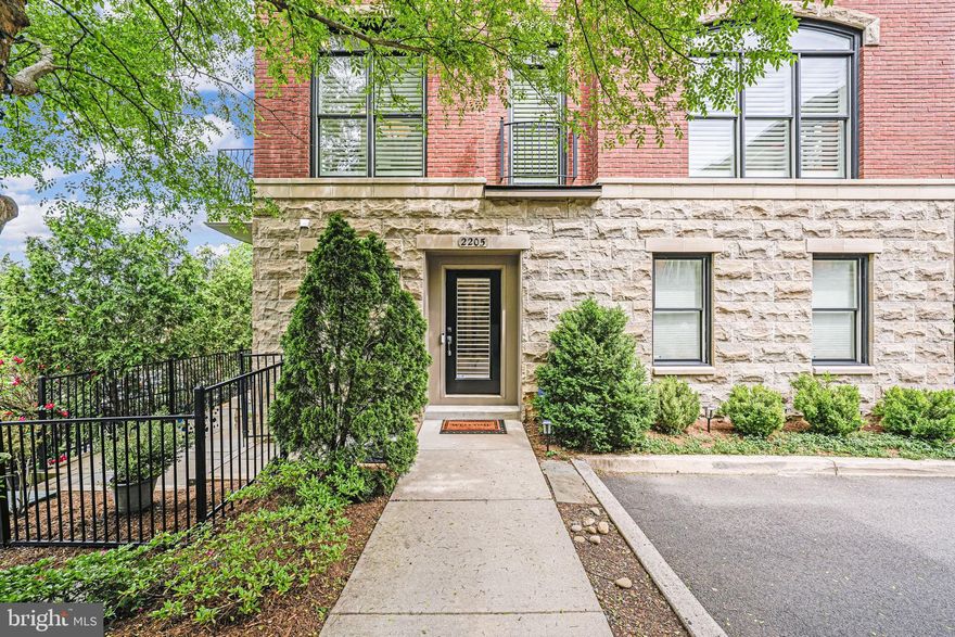 Experience all the very best Arlington has to offer in this sophisticated and private large brick and stone townhome! A five minute walk to Courthouse metro station allows for super convenience and ready access to D.C., shops and restaurants. This elegant townhouse splits 1,985 SF into 3 levels, complete with a 2 car garage, 9 foot ceilings and gleaming hardwood floors The open kitchen/living level is awash in natural light filtered by beautiful white plantation shutters. Three bedrooms on the bedroom level with hall bath and primary suite with walk-in closet and double sinks.

A dedicated laundry room is located just inside from the garage, while a full bath and bedroom on the first level make for an ideal guest room or office. The patio in the backyard provides a private getaway.

On the second level you'll find a spacious, bright, eat-in kitchen, with Stainless Steel Jenn-Air appliances (New in 2022), and seasonal views of the National Cathedral. This space is complete with a small north-facing balcony, making the open dining area/kitchen the place for the whole house to be. The spacious living room features a gas fireplace, plenty of room for your furniture, and has an alcove (with built-ins) making a perfect office.

This prime location is just .4 miles from Courthouse metro, 1 mi. from the Key Bridge (easy access to Georgetown Restaurants and Shopping), and minutes to National Airport. Mom's Organic Market is just across the street, and it's only a few short blocks to all the restaurants, shopping, and entertainment that the Courthouse area has to offer.