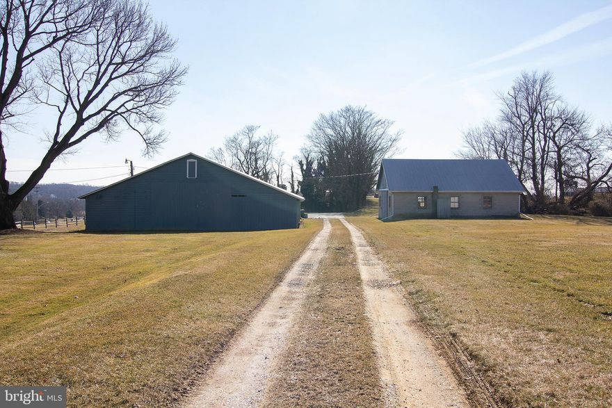 REDUCED!  Priced BELOW appraised value. Price INCLUDES 3 lots: Main lot Parcel 1993= 2.36 acres, Parcel 1992 (Lot has MAIN HOUSE on it)=5.68 acres (2018 Taxes-$5434), Parcel 1991; .99 acres (2018 Taxes= $143).  All 3 Parcels=Land Use Code R-10,000. Contiguous to Commercial land. Always want to own a Bed And Breakfast!? Thought about developing land? Farmhouse majestically sits atop the 9+ (all parcels) acre property offering one of the best views in Westminster, and a convenient location. 3000 sq. ft. 4 bedroom, 2 bath home.  The current owners have made it their lifestyle to enhance its condition while being mindful of its historic value; however, they are ready to downsize, and leave the keys to another owner willing to celebrate and care for College View!  A truly charming experience. Many of the original details remain including hardwood floors, fine stone mantels and multiple, original doors.  Main House boasts original log home w/ updated addition including dining room and kitchen w/ custom cabinetry and radiant heat. Main floor Washer/Dryer. Water neutralizer, Water Softener. Well and public sewer. 2nd Level Fireplace, 2nd Level Porch. A complexity of wonderful outbuildings, including a 2-Car Garage w/ Auto/Electric Doors, Cattle Barn, Smokehouse w/ Fireplace and 2nd Level, Wagon Shed, Cinder block Workshop, & Milk House. Please do not hesitate to contact the co-agent to view/walk the property.