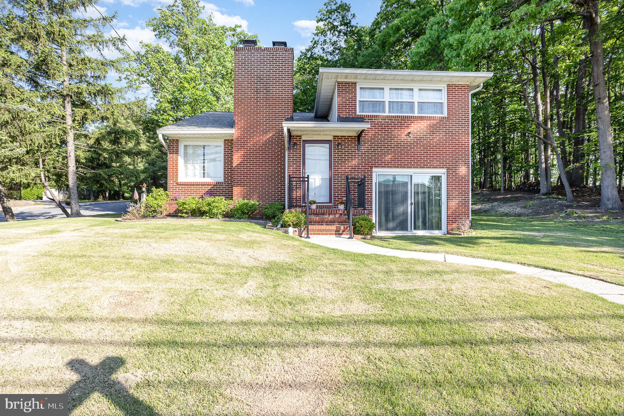 Welcome to this wonderful brick 4 story home with 3 beds and two full baths on a large corner lot with a driveway off of the side street so to avoid the busy road. The home sits on a gorgeous lot with a grassy front and rear yard that is surrounded by forest. Pull into the driveway and park in the small lot, and take the steps into the front sunroom. the door from the sunroom leads into a modern dine in kitchen with room for dining, plenty of counter space, cabinetry and stainless appliances. The kitchen leads out into a large living room area with hardwood flooring and a fireplace. A door off of this main floor living area also leads out onto the covered brick front porch and front walkway. A half flight of stairs up from this level leads to a full bath with tub/shower combo, and two bedrooms. A half flight of stairs down from the main level leads to another large living area, prefect for relaxing/entertaining or having a separate space from the kids. There is a third bedroom on this level. Another short flight of stairs leads to the basement which has been fully waterproofed, has tons of room for storage, laundry and mechanicals, and also has a second full bath with a tub/shower combo. This home is pristine, the paint and floors are fresh, and the location is phenomenal situated in Perry Hall, between Harford and Bel Air Rd and a few minutes from 95 and 695! Come see it today!