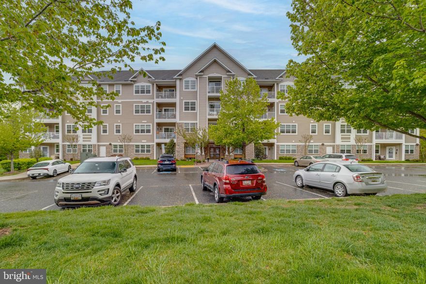 MacPhail Woods is Bel Air's premier 55 and over condo community.  Welcome to this well maintained 2 bed, 2 full bath modern condo that comes with two deeded garage parking spots.  Enter into the lobby and take the elevators to the 3rd floor.  Walking into the unit brings you to an open concept dining and living room area with crown molding and  engineered hardwood flooring throughout.  To the right is the kitchen with custom cabinetry, granite countertops, backsplash and all stainless steel appliances.  Back in the main living room area, if you go to the right you'll reach a small hallway that leads to a full modern bath with a tub/shower combo as well as a carpeted bedroom.  To the left of the main living area a door opens into the carpeted owners suite with two walk in closets and its own large private bathroom with double vanities and a walk in shower.  Also in this unit is a walk in laundry room with custom cabinetry and access to mechanicals.  There is a balcony with multiple access points that offers a serene space to relax and enjoy the nice weather.   The two deeded parking spots are tandem in the garage: 26 & 26A.  Be sure to check out the club room on the second floor, and there are two storage rooms on floors 3 & 4.  This condo is immaculate and well maintained and is waiting for you to come call it home.  Come see it today!