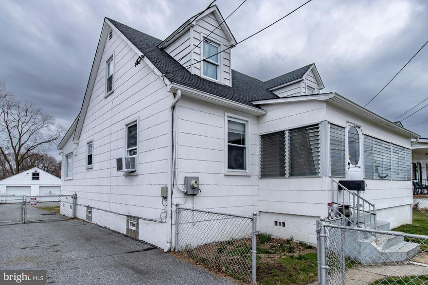 Welcome to 338 Maple Avenue, a charming and spacious residence offering endless potential to make it truly your own. Enter through the enclosed porch, an inviting entryway that sets the tone for the character found throughout the home. This property stands apart with its beautifully preserved natural woodwork and custom touches. Hardwood floors are present throughout the living room, hallway, and main‑level bedrooms, adding warmth and cohesion. The main level features a generously sized living room that flows into an open kitchen equipped with stainless steel appliances. Adjacent to the kitchen is a welcoming dining area—perfect for hosting family gatherings or enjoying an intimate dinner. The dining room opens directly to the family room and provides access to one of the home’s main‑level bedrooms. Cedar closets throughout add both charm and practicality, offering natural protection and a cozy aesthetic. Both main‑level bedrooms, paired with a full bathroom, offer the convenience of a complete one‑level living—perfect for those who prefer to avoid stairs. Upstairs, you’ll find two spacious bedrooms, including one with its own cedar closet. The upper level provides comfort, privacy, and ample storage options. The partially finished lower level offers even more versatility, with the potential to add an additional bathroom. A convenient walkout leads to the expansive backyard, where you’ll find a two-car garage complete with electricity and running water. The garage also features a covered carport and an upper-level space ideal for storage, a playroom, or a quiet retreat. The long, paved driveway accommodates multiple vehicles—perfect for guests, an RV, or a safe play area for the kids. The fenced yard surrounds this impressive 2,275 sq. ft. home, offering both space and privacy. This home is truly a must see. Ideally located near restaurants, shops, and everyday conveniences, with easy access to Routes 695 and 95. Schedule your appointment today—your new home awaits.