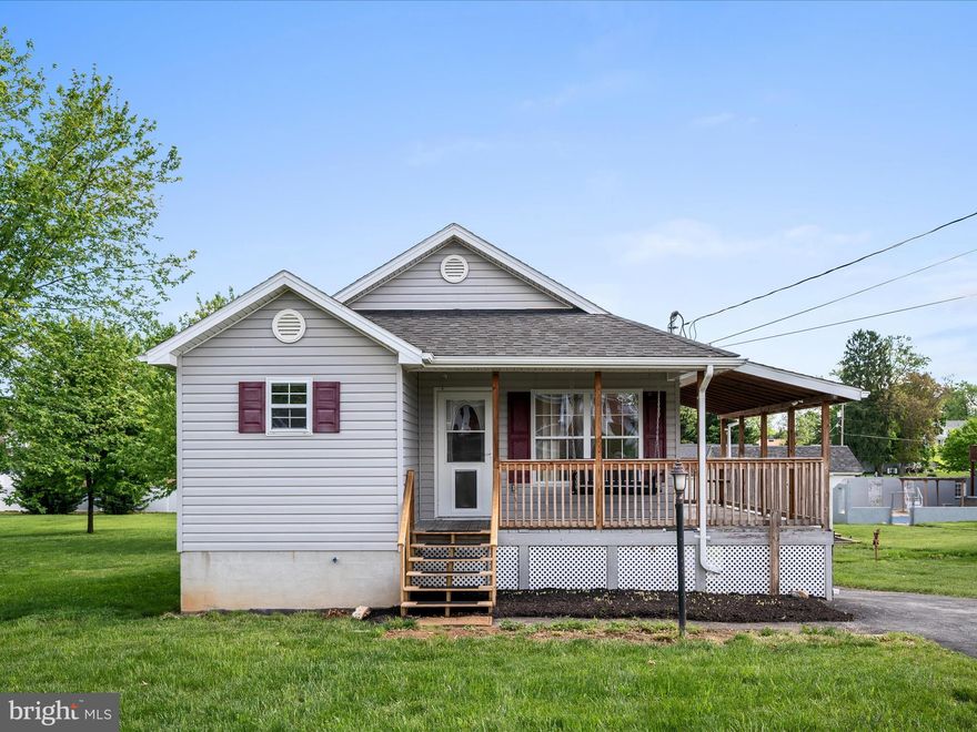 Charming Rancher in the Heart of Inwood on Almost an ACRE! This perfect cozy rancher offers the ideal blend of comfort and convenience. Enjoy an open-concept layout with hardwood floors throughout the kitchen, dining, and living room combo—perfect for everyday living and entertaining. The home features two spacious bedrooms, including a primary suite with a private en suite bath. A full hall bathroom includes a desirable walk-in shower for added ease. Relax and unwind on the inviting wrap-around front porch, ideal for morning coffee or evening chats. The nicely finished walk-out  lower-level family room is filled with natural light and includes an adjoining unfinished area with potential for a third bedroom. Outside, the expansive side yard boasts mature trees and open space—ideal for gardening, pets, or future outdoor projects. Conveniently located near shopping, dining, and quick access to I-81 for an easy commute.