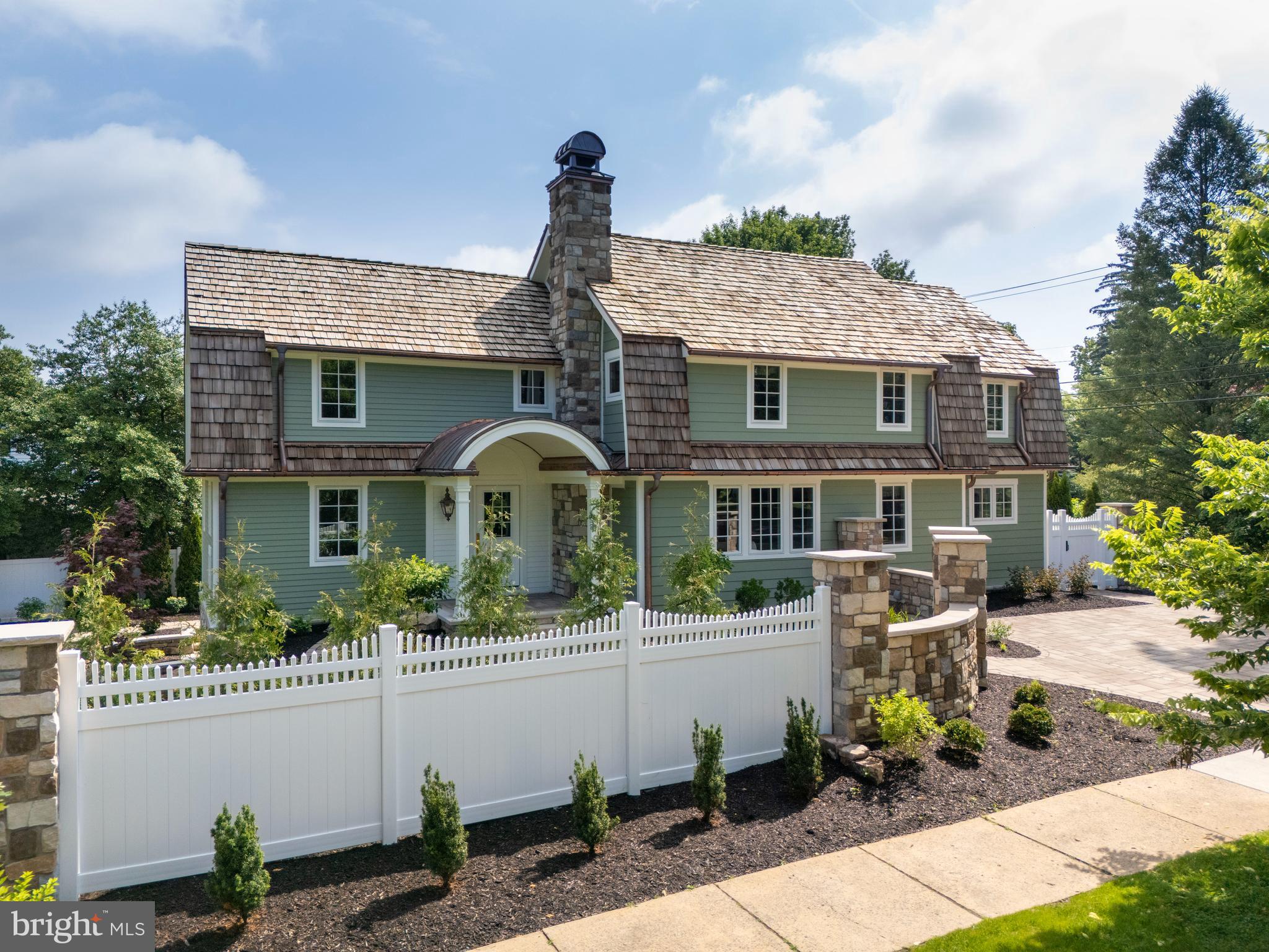 Located in the highly desired historical district of College Heights, steps away from Penn State University, 619 McKee Street is a showstopper! From the moment you step inside, this home tells a story of craftsmanship and quiet luxury. The kitchen stuns with dramatic Italian Calacatta Gold marble, a handcrafted ILVE Majestic II range with brass accents, and fully paneled Sub-Zero and Wolf appliances, all framed by custom inset cabinetry and a sunlit breakfast banquette. Site-finished white oak floors run throughout the main level, met by curated lighting and a stairwell wrapped in gallery-style wallpaper. Each of the three full baths is elegantly dressed in waterjet-cut marble, furniture-style vanities, and a mix of polished nickel and unlacquered brass. In the primary suite, a clawfoot tub rests beneath Chinoiserie wallpaper, offering indulgent, spa-like charm with a sense of old-world romance. A Tripp Lite tech closet ensures seamless smart home connectivity, while the lower level adds wide-plank LVP, built-ins, and flexible living space. Outside, enjoy thoughtful hardscaping, a fenced yard, and a detached garage—all beneath a cedar shake roof and copper gutters designed to age gracefully, built to grow only more stunning with time.