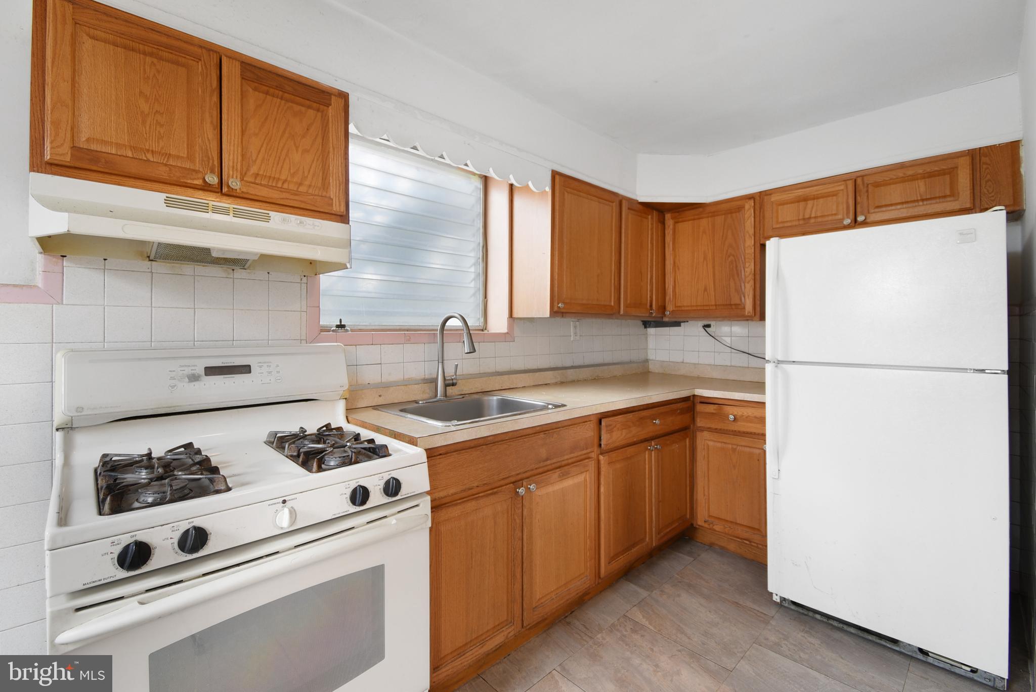 Welcome to 1254 Wycombe Ave, a handyman special end of the row townhome nestled in the sought-after
Lansdowne Park section of Darby. This 3-bedroom, 1-bathroom diamond in the rough could be brought back to life with a few minor updates or could be completely transformed with a whole house renovation, making it an ideal choice for both the handy first-time buyers or the savvy investor. Step inside to discover hardwood floors that flow throughout the main and upper levels (under the carpeting). With windows on three sides, the home is bright and inviting, ready for you to make it your own. The kitchen features durable oak cabinetry, tile backsplash and laminate countertops. Three spacious bedrooms and a full bathroom completed the upstairs floor. The basement is mostly finished, and the garage has been converted to additional living space. Enjoy the outdoors on either the front or back patio, and the entire front and side yard are fenced-in, ideal for your pup or for relaxing. Outback, a driveway offers convenient one-car parking. Additional highlights include washer/dryer hookups in the basement. Don't miss your opportunity to grab some sweat equity and make this home your own. Schedule your tour today! One of the owners is a licensed real estate salesperson in the state of Pennsylvania.