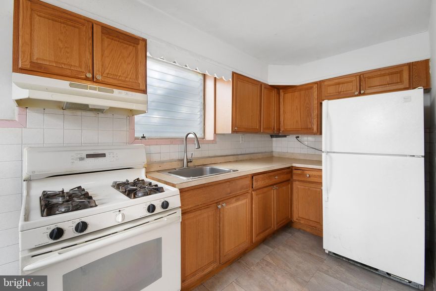 Welcome to 1254 Wycombe Ave, a handyman special end of the row townhome nestled in the sought-after
Lansdowne Park section of Darby. This 3-bedroom, 1-bathroom diamond in the rough could be brought back to life with a few minor updates or could be completely transformed with a whole house renovation, making it an ideal choice for both the handy first-time buyers or the savvy investor. Step inside to discover hardwood floors that flow throughout the main and upper levels (under the carpeting). With windows on three sides, the home is bright and inviting, ready for you to make it your own. The kitchen features durable oak cabinetry, tile backsplash and laminate countertops. Three spacious bedrooms and a full bathroom completed the upstairs floor. The basement is mostly finished, and the garage has been converted to additional living space. Enjoy the outdoors on either the front or back patio, and the entire front and side yard are fenced-in, ideal for your pup or for relaxing. Outback, a driveway offers convenient one-car parking. Additional highlights include washer/dryer hookups in the basement. Don't miss your opportunity to grab some sweat equity and make this home your own. Schedule your tour today! One of the owners is a licensed real estate salesperson in the state of Pennsylvania.