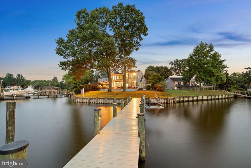 This is IT! This home sits in a hidden enclave, and these views will take your breath away!

Situated on a point of land with panoramic views of Bodkin's Main Creek, this stunning home has all the bells and whistles and 110" of newly updated bulkheaded shoreline and features a private renovated pier with 6-8' depth and maintenance-free composite material on both! Enjoy evening sunsets, morning sun, and a parade of stunning boats headed into the yacht basin.

Windows and water at every turn! The renovated kitchen features quartz counters, gas cooking, stainless steel appliances, and 42" cabinets and opens to multiple flexible living spaces. The cozy and spacious two-story living room has the original stone fireplace and gas insert, hardwood floors, and vaulted and beamed ceilings! You can't miss the waterfront great room with unbelievable panoramic water views, custom built-ins, and french doors leading to the deck where you can enjoy the evening shade, yard and pier! Office space and laundry just off the kitchen, along with three main-level bedrooms, two full baths, and tons of storage!

The second-level waterfront primary suite has incredible views of the Bodkin, a large walk-in closet, and a renovated ensuite bath beautifully done with a stand-alone soaking tub situated for enjoying the views during your bath, a radiant heated tile floor, two vanities and custom closets! Don't miss the pull-down steps to the attic that is floored and has TONS of storage and potential living space too!

Substantial improvements include an updated septic system, Hardiplank siding, bay windows, windows in the waterfront great room & bedroom, doors, a paver driveway walkway & patio, and roof! Central heating in '23 (baseboard was eliminated), Bosch condenser '23, W&D '22, pier & bulkhead '22, MBR mini-split '23, Basement crawl space cleared, cleaned & sealed '23, Self-draining dehumidifier '23, Fresh paint '21, custom closets '21 and an electric conduit run to the pier. 

If you're looking for incredible views and a protected waterfront, it doesn't get any better than this! It is NOT in a flood plain, and no flood insurance is required!