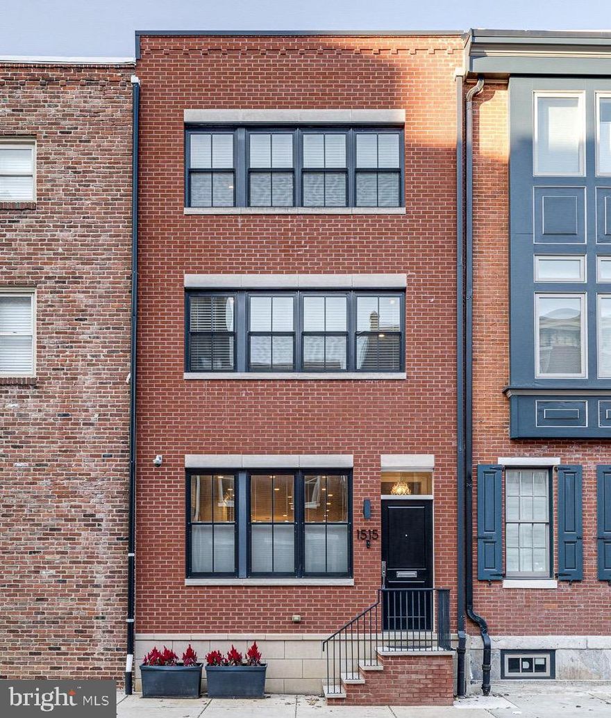 Introducing 1515 Lombard Street – a home developed with the unique vision of beautiful, high-quality finishes coupled with comfort and ease of functionality. This one-of-a-kind Rittenhouse Square neighborhood residence is located in the desirable GREENFIELD school catchment. Just steps in any direction of this home is all that makes up a city and all that is uniquely Philadelphia; from the arts, to the square, to professional sports/entertainment, to your choice of dining. This is the perfect place to call home. This townhome residence was built in 2017 (approximately 3.5 years of Tax Abatement remain, 2023 Tax amount $7,964.00) and includes 4 spacious bedrooms with large closets, 3 gorgeous baths and a powder room. Offering approximately 3,665+ square feet, private on-site gated parking and a generous roof deck with exceptional, unobstructed Center City views. Through the entrance door/vestibule to the Great Room, one is greeted by soaring ceiling heights, beautifully stained custom oak hardwood flooring and a stunning full floor-to-ceiling Porcelanosa tile encased, gas fireplace. Sun pours through the expansive windows of this south-facing townhome as well as down through the staircase skylight which emanates light throughout the home. The expansive custom gourmet Chef's Kitchen, open to the Great Room, features custom inset cabinetry finished in white, with a full-wall pantry, offering extensive storage and style and complimented by stunning, Super-White, Quartzite countertops. The appliance package includes a 6 burner Wolf stove with convection oven, Zephyr hood, Jenn-Air panel ready refrigerator, Jenn-Air panel ready dishwasher & Jenn-Air microwave drawer. The Powder Room finished with Kohler fixtures and Carrara hex tile is well placed for privacy and is distinctly finished with a luxurious touch. The 2nd floor offers two generous full bedrooms with expansive closets, soaring ceiling heights and a stunning Carrera marble bath in a beautiful herringbone finish with floor to ceiling tiles and Kohler fixtures. The Laundry Room furnished with cabinets and full-sized washer & dryer is conveniently found on this floor as well. For the utmost privacy and refuge, the 3rd floor features the Primary Bedroom Suite including a large sleeping area with 12’+ ceilings, an expansive custom walk-in closet The Primary Bath is exceptional featuring an oversized glass-enclosed shower with floor to ceiling Carrara tile, Kohler fixtures throughout including: 2 shower heads, a rain head, a hand shower, double basin white vanity with a Carrara marble countertop. Another spacious bedroom and full bathroom are on this level as well. Just one flight up the naturally lit oak staircase with custom railings is direct access to the generous and beautifully appointed roof deck featuring eye-popping iconic city views. The lower level of the residence has been beautifully finished with polished concrete floors with high ceilings, the perfect space for a kids play room, a theater or an in home gym. Additionally, the home office exists on this level. High-end, custom finishes throughout include generous base & case molding, solid core 7’ doors, Cat 5 wiring throughout, 2 hotspots, WAC brushed nickel stair lighting, Sonos home automation & interior sound systems, Honeywell wifi enabled thermostats, Honeywell security system, hardwired smoke & carbon monoxide detectors, quiet bath exhaust fans, dual zone 14 seer AC system, dual-zone energy-efficient gas heat, security cameras and much more.