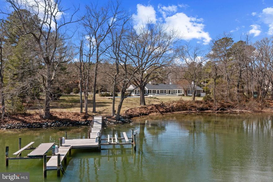 One-level living in this exceptional ranch-style waterfront home on the Wye River!  A rare opportunity to embrace the perfect balance of relaxation, recreation, and timeless beauty. Designed for effortless indoor-outdoor living, this light-filled, river front home offers three well-appointed bedrooms, including a spacious primary suite with an ensuite bath and stunning water views. The heart of the home is a warm and inviting open-concept kitchen, dining, and living area, anchored by a central fireplace that brings everyone together. An adjacent office/bonus room adds versatility, whether for work, hobbies, or additional guest space. Step out to the screened porch, where stone floors and a wood ceiling sets the tone for serene mornings and unforgettable evenings. Overlooking the sparkling pool and expansive waterfront, this space is perfect for entertaining, unwinding, and making lasting memories. The sprawling backyard invites endless outdoor fun, from summer barbecues and crab feasts with famous Wye River crabs, to quiet afternoons soaking in the breathtaking views. For water lovers, the private pier with two lifts sits in a quiet cove that provides direct access to the Wye River, offering endless adventures—boating, crabbing, fishing, paddleboarding, or simply enjoying the peaceful water. Whether lounging by the pool, hosting gatherings on the porch, or taking the boat out for a sunset cruise, every moment here is designed for the ultimate waterfront lifestyle. With a two-car garage, wood floors, and a layout that blends comfort with style, this home is move-in ready yet offers the opportunity to bring your vision to life. This is more than a home—it’s a place where unforgettable memories are made and the waterfront lifestyle can be lived to the fullest. Welcome Home!
